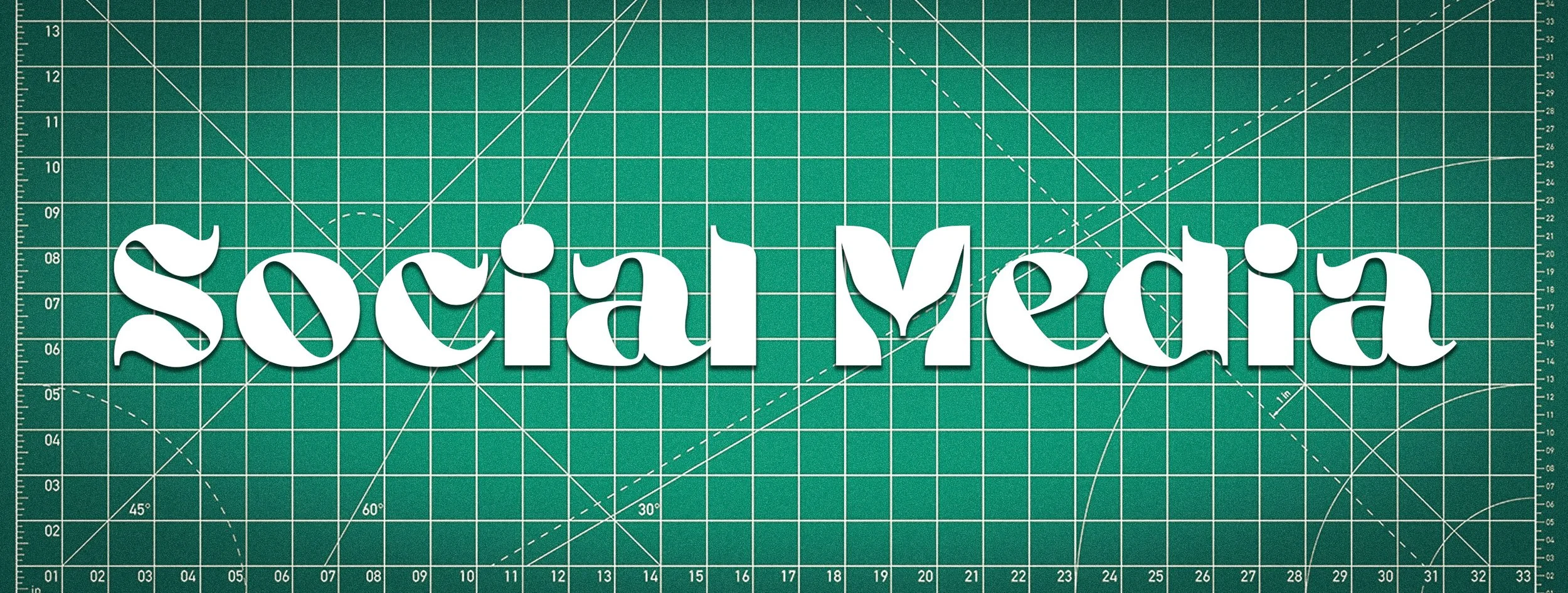 Lettering spelling 'social media' on a green cutting mat background.
