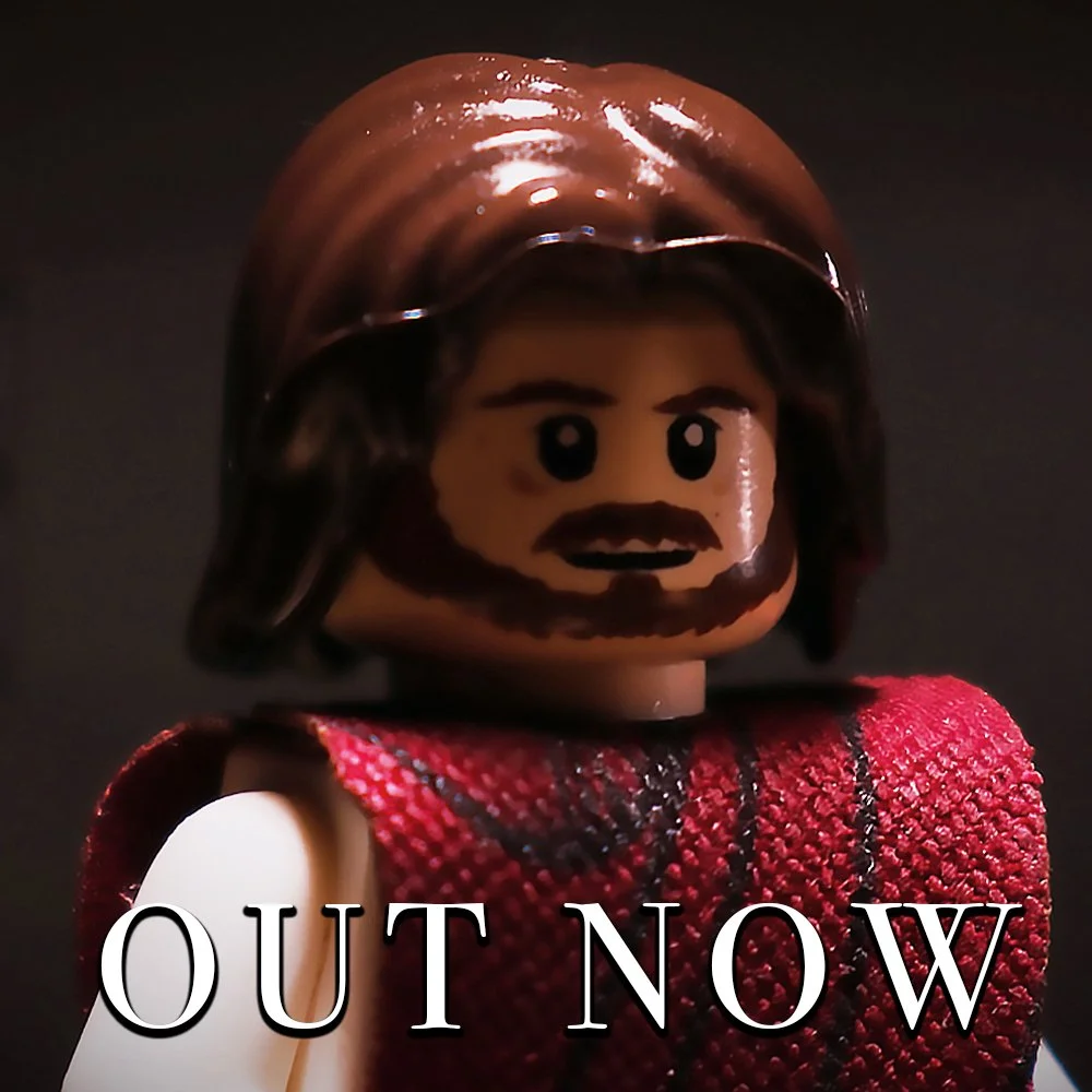 Close-up of a Lego character of Jesus. The text 'OUT NOW' is at the bottom of the image.
