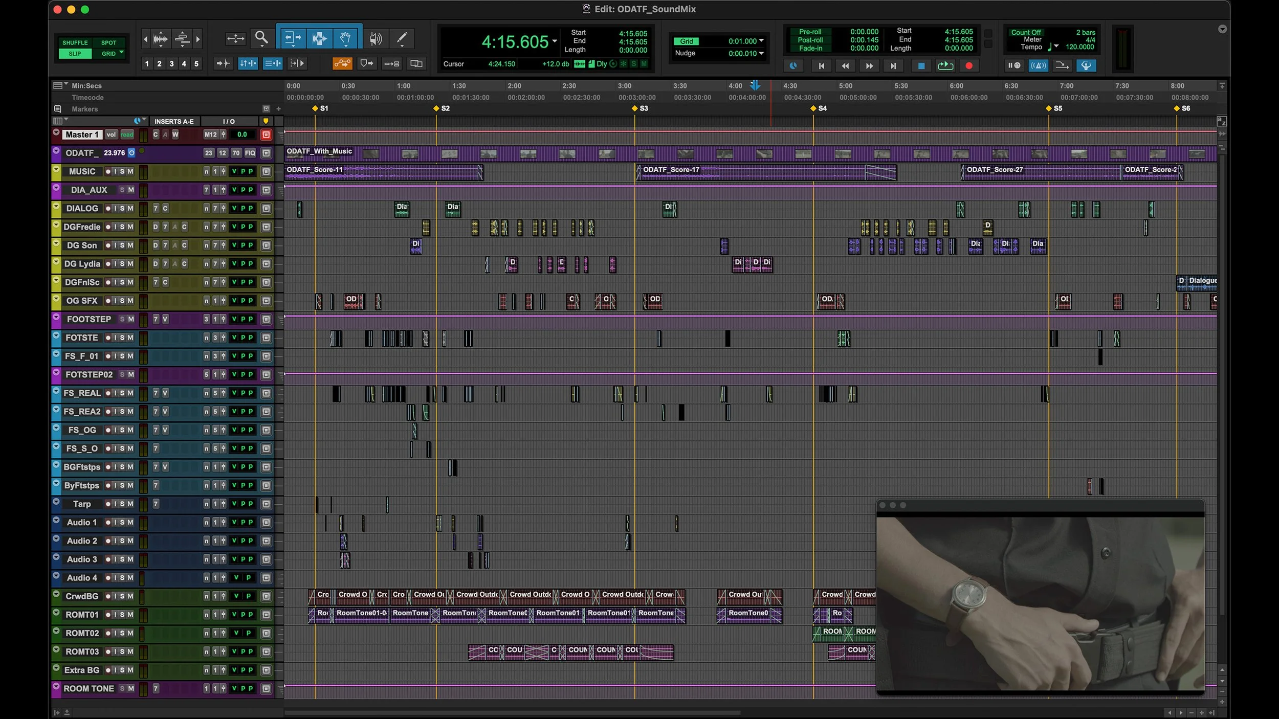 Screenshot of digital audio workstation software showing multiple tracks and sound editing elements on a dark interface, with a small inset of a person wearing a jacket and watch on the bottom right corner.