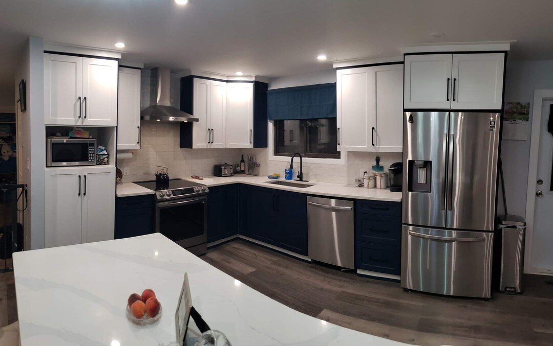 Check out this this beautiful kitchen renovation we just completed for our friends in #pentictonbc #penticton! Custom Dark Blue Shaker Cabinets and Kitchen Island made at our in-house cabinet shop as well as all new appliances and hood fan, flooring,