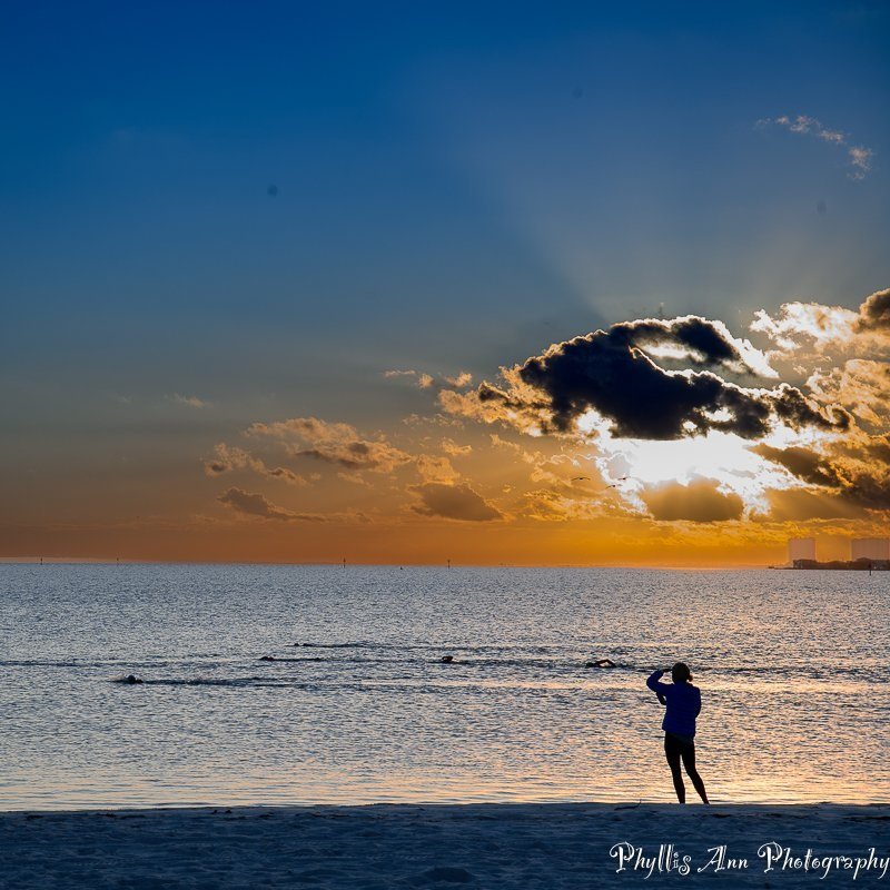 Swimmers at sunrise