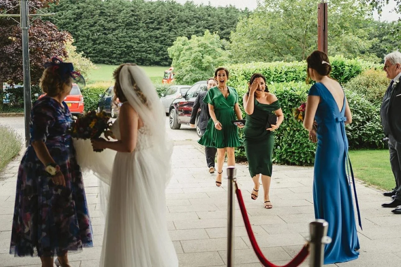 Wedding guests arriving at a venue before the ceremony begins.