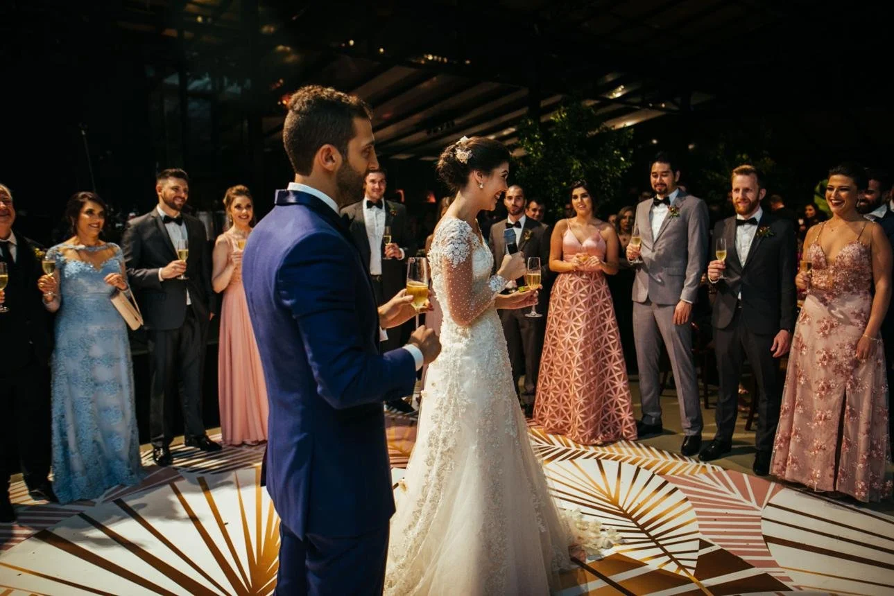 Bride and groom enjoying time with family and guests while wedding logistics are managed behind the scenes