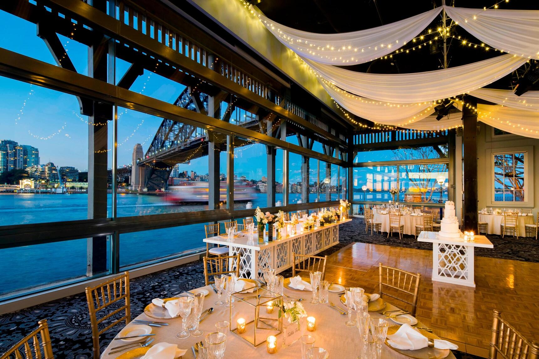 Sydney harbour wedding reception venue with views of the Harbour Bridge, styled tables and dancefloor