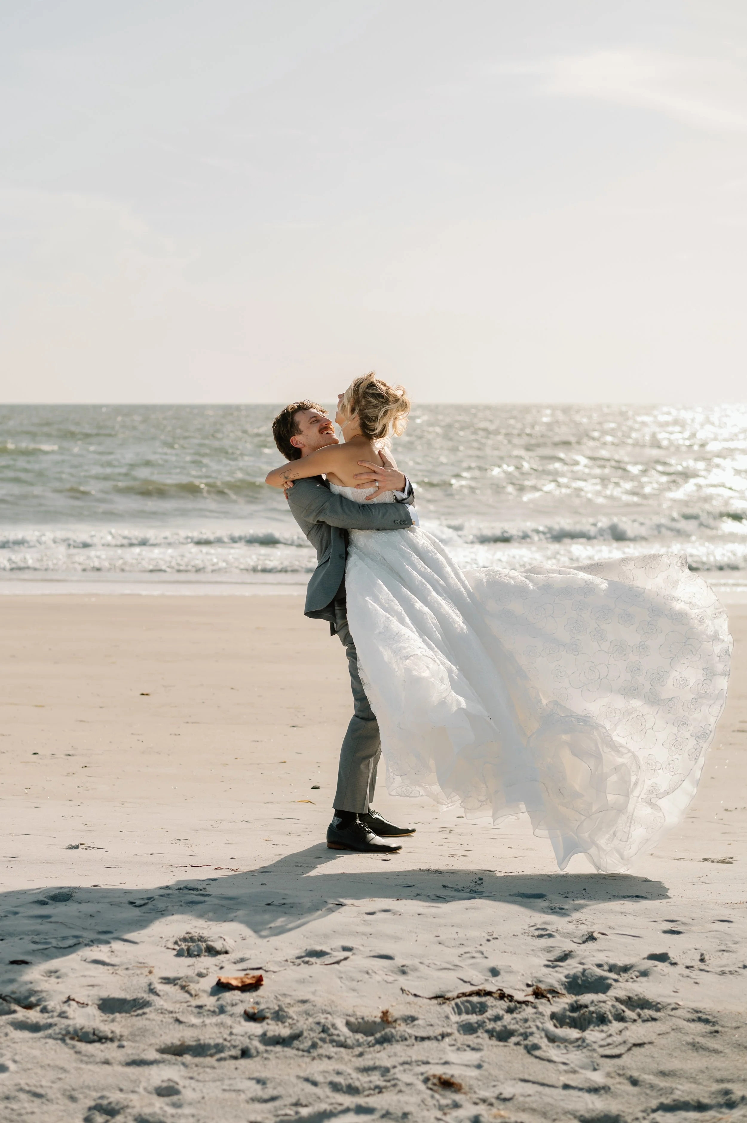 Couple spinning on the St. Pete Beach after their wedding