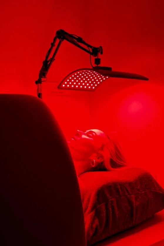 Red light therapy at Sweatland Austin using an LED panel