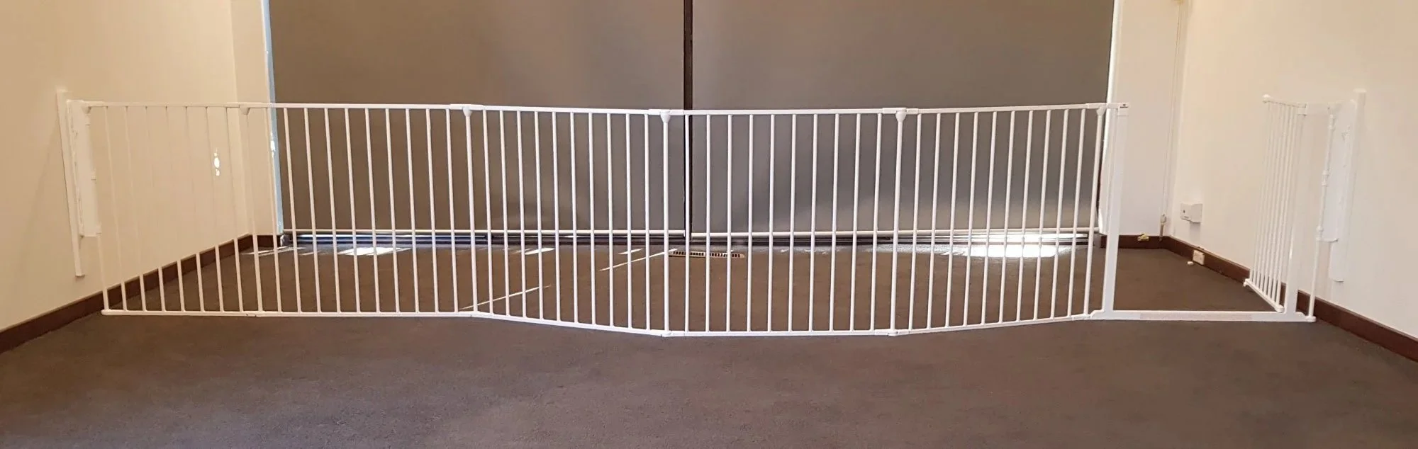 Long white room divider across a carpeted room