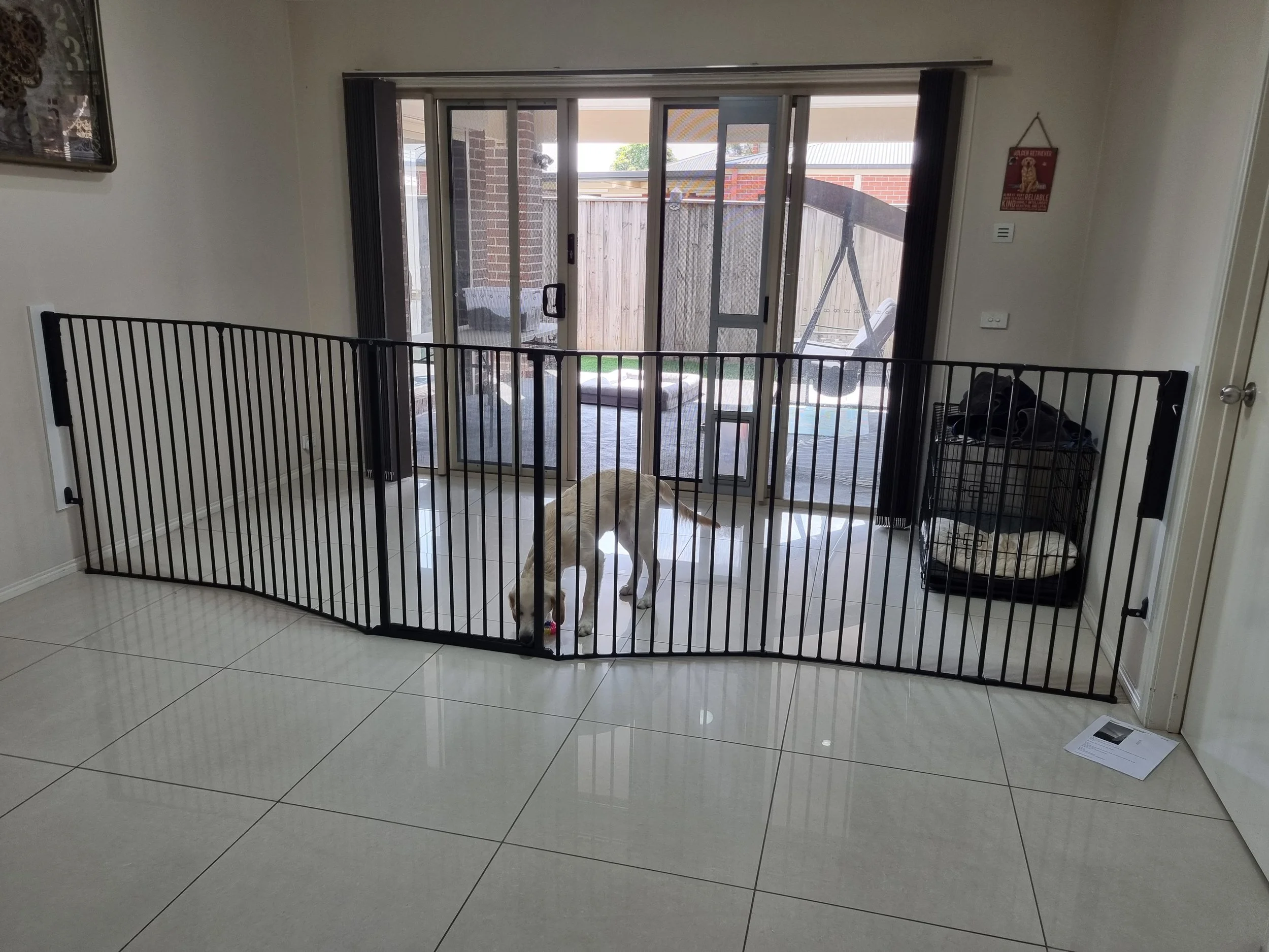Black room divider across a tiled living area