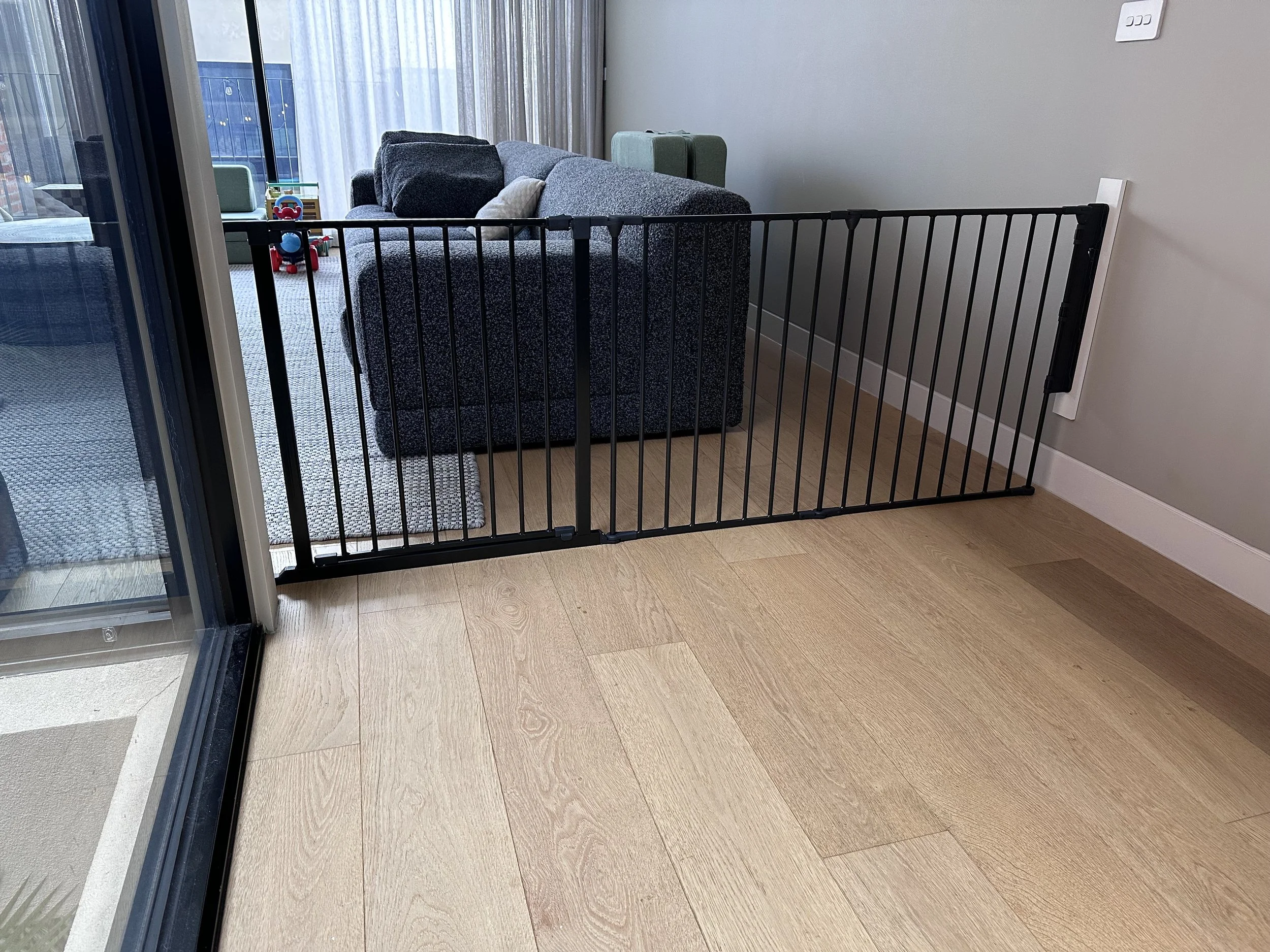 Black room divider in a living room beside a sofa