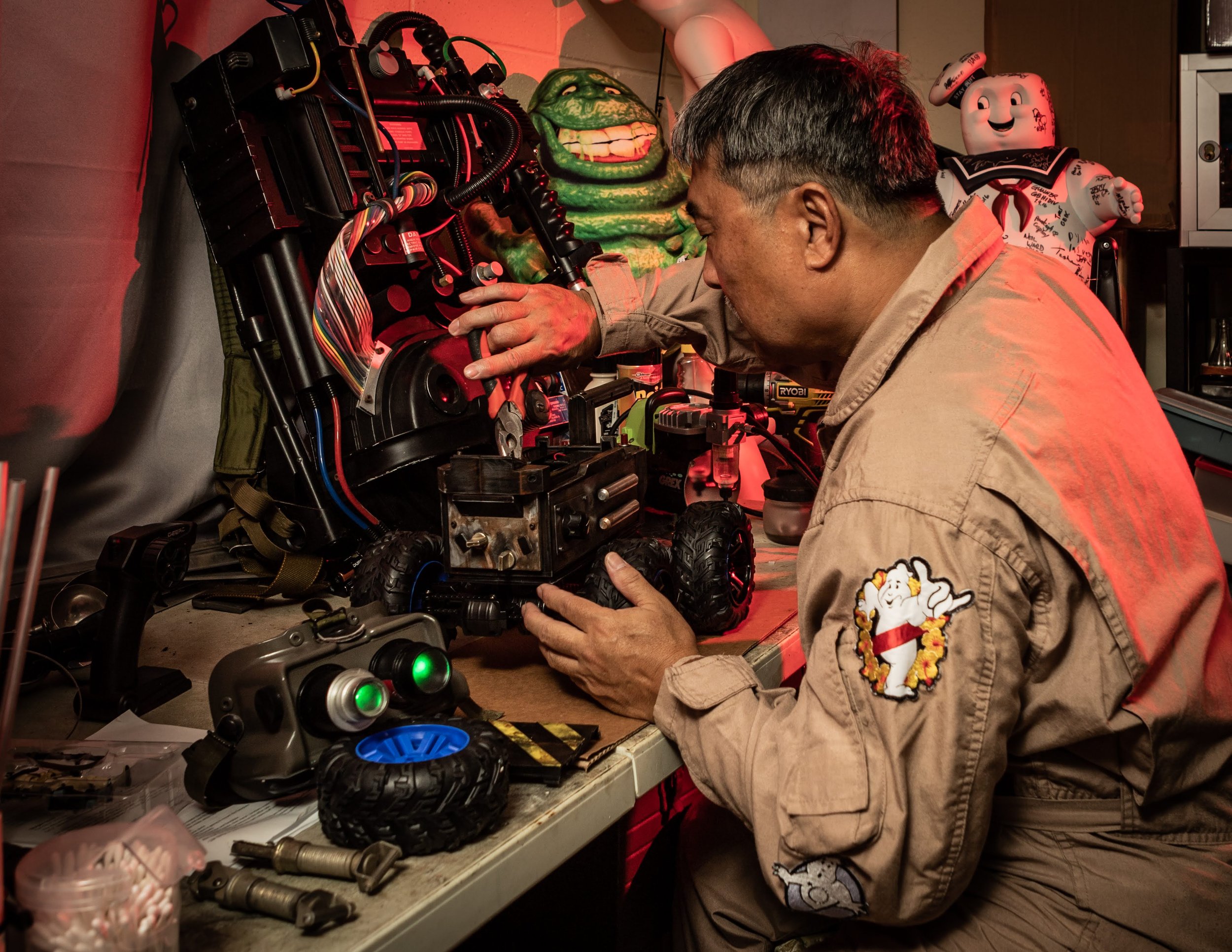  Okamoto proudly sports his prized Ghostbuster uniform, while sifting through his sentimental stash of prized film memorabilia, including proton packs, motion trackers, and more.   