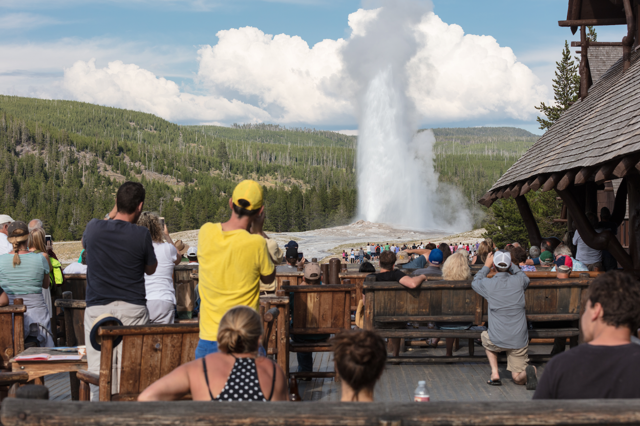  People watching Old Faithful erupt from the Old Faithful Inn ( photo courtesy National Park Service/Jacob W. Frank ).  