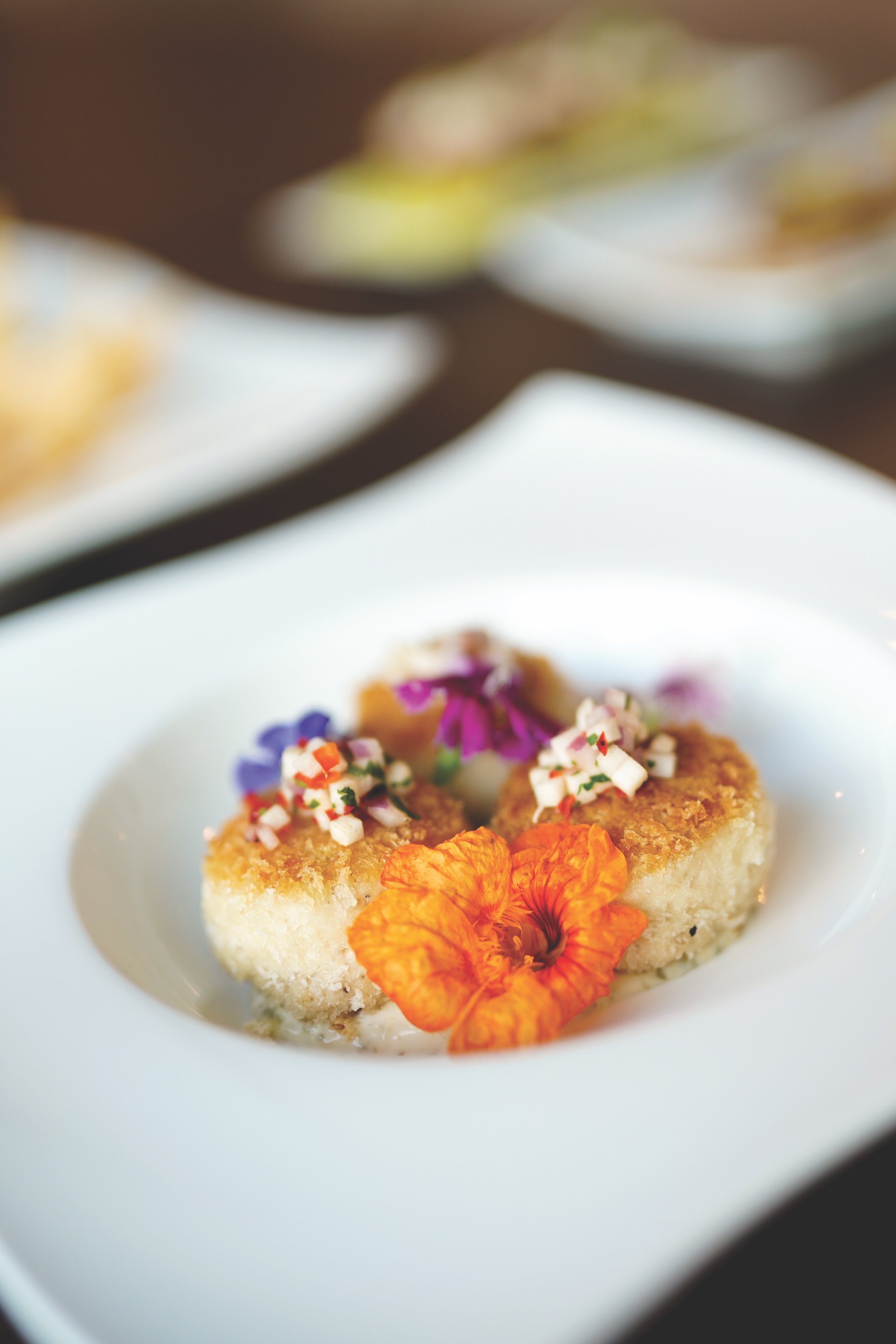  Gorgeous crusted scallops with edible flowers is just one of the many picturesque menu items at MW Restaurant. 