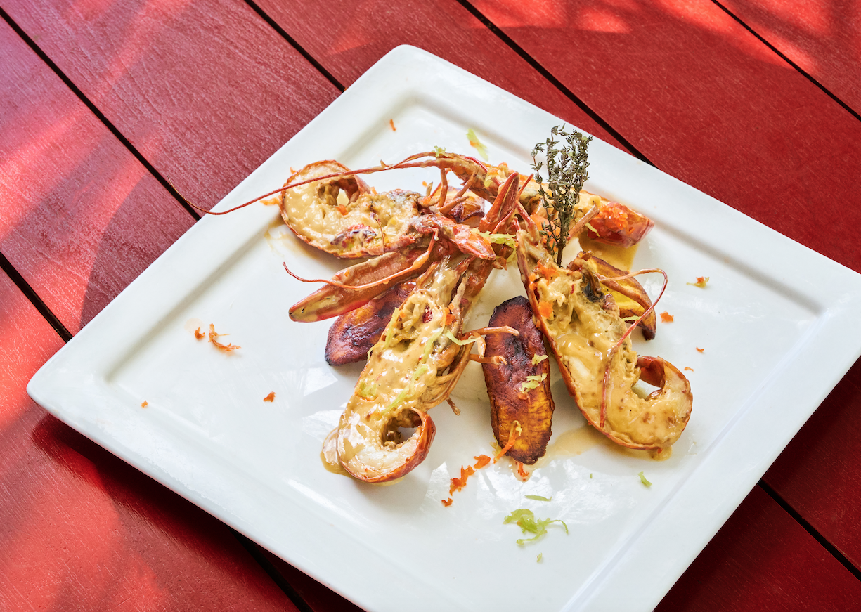  Colorful creole cuisine will tantalize your palate with flavors of the tropics, whether it be poulet boucané (chicken cooked with Antilles pep-  pers and spices) or grilled langoustines (lobster). You’ll also want to stop and visit local vendors se