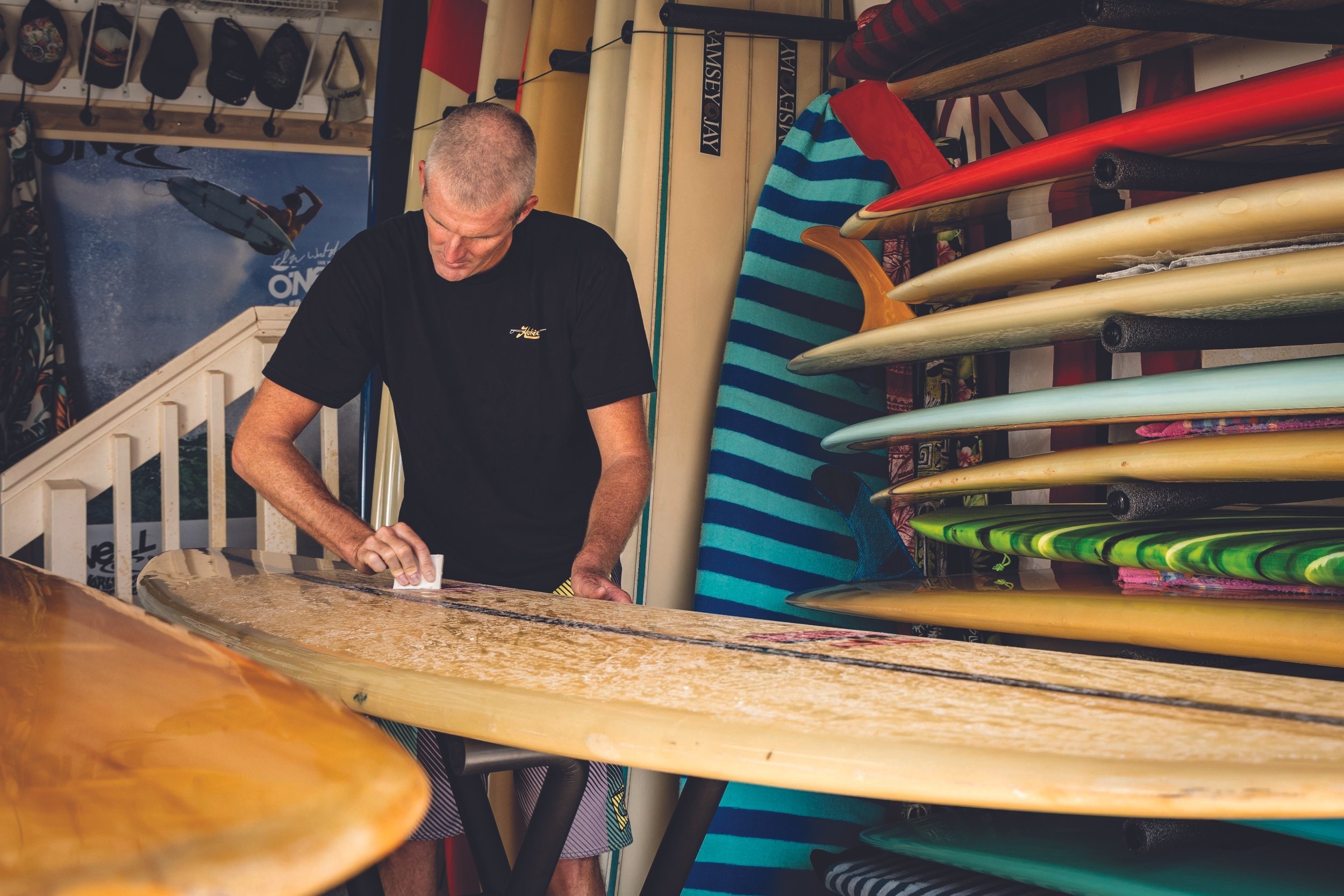 Darren Park waxing a Morey Pope Contender; board in the quiver from a who’s who of shapers. (Photos by Brandon Miyagi.)