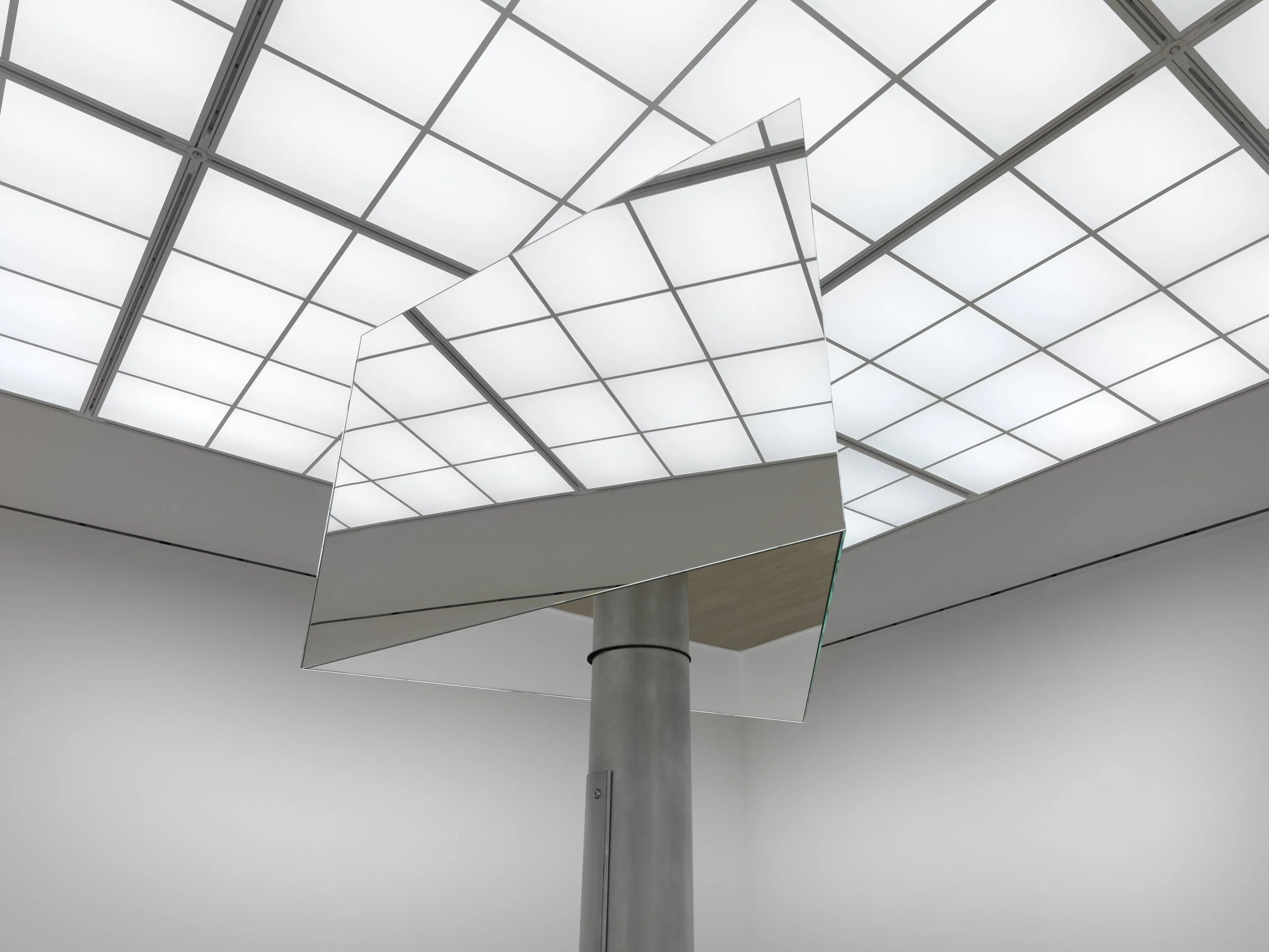  Detail of Mark Wallinger’s Superego (2016). A mirrored sculpture, inspired by the revolving New Scotland Yard sign, evokes authority and vigilance, reflecting viewers while remaining distant above them.