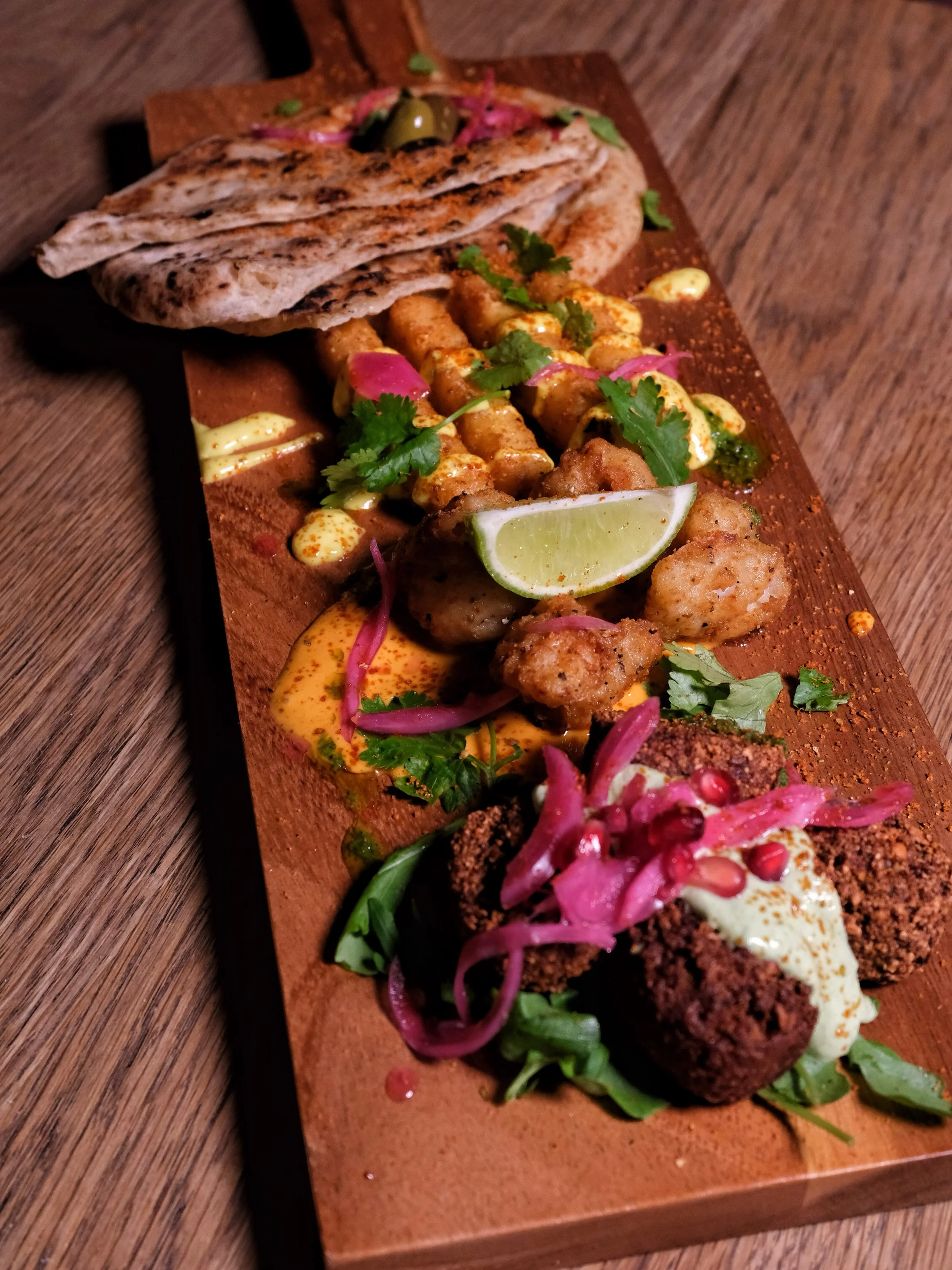 Sharing platters are now available in the Boardroom.

Order to the table and share between rounds:

Mosaic, Mezze medley: crispy spiced squid with harissa mayo and lime, falafel with coriander sauce and pickled red onion, halloumi fries with house pi