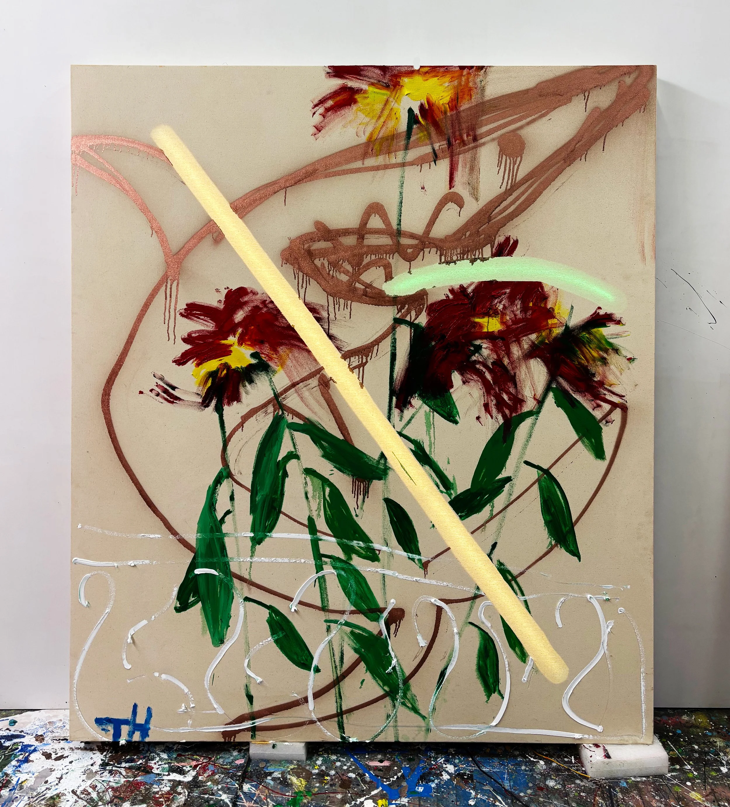 Abstract mixed media artwork on a canvas with painted and sprayed elements, including swirls, drips, and bold strokes in red, yellow, green, and white, along with neon light behind canvas