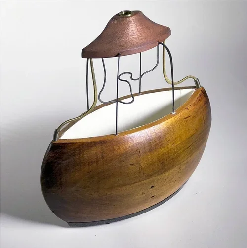 "Loupe" by John T. Upchurch and Rebekka Federle, 10" x 10" x 4", Antique print material, wood, steel and brass wire, paper, found objects