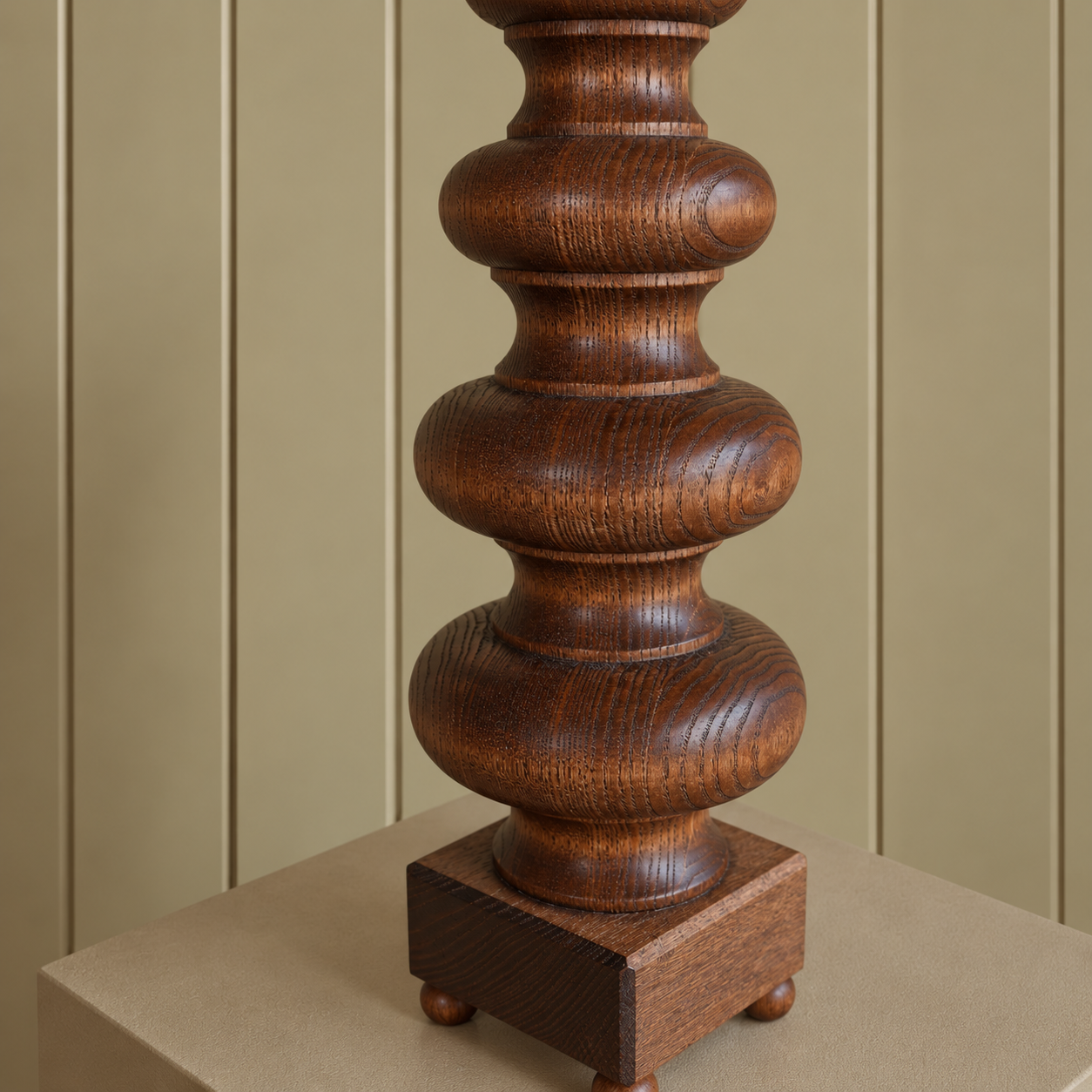Turned Walnut Lamp Base on Taupe Plinth.png