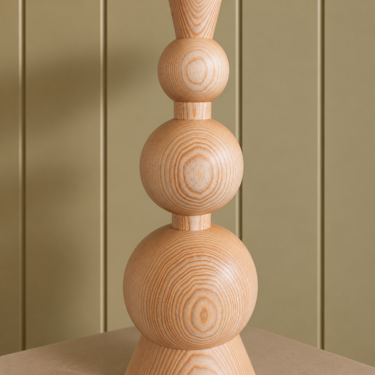 Turned Wood Sculpture on Taupe Paneling.png