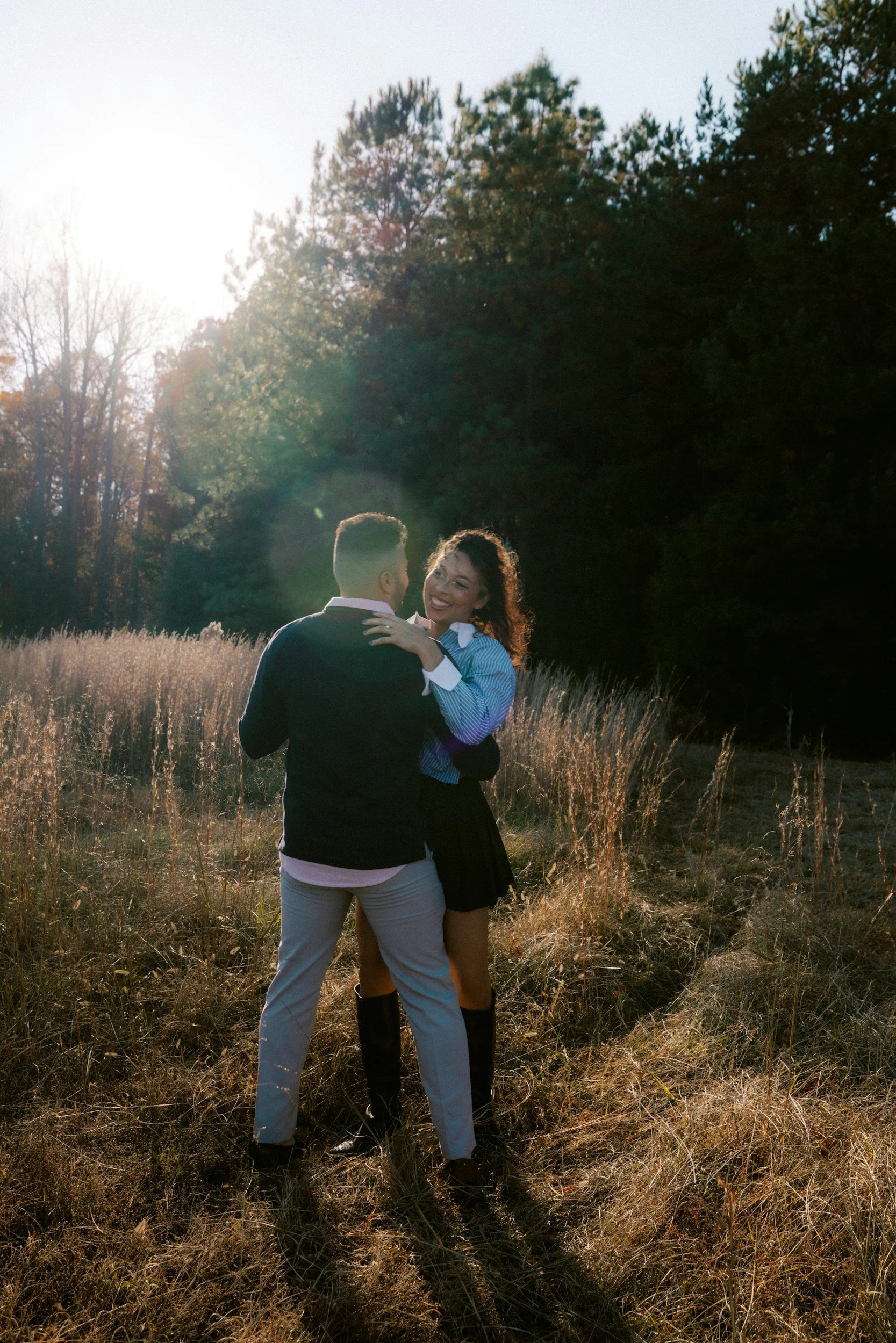 Couple dancing in a field at sunset at Dancing Goat Therapy Farm in Fredericton, enjoying a romantic outdoor experience