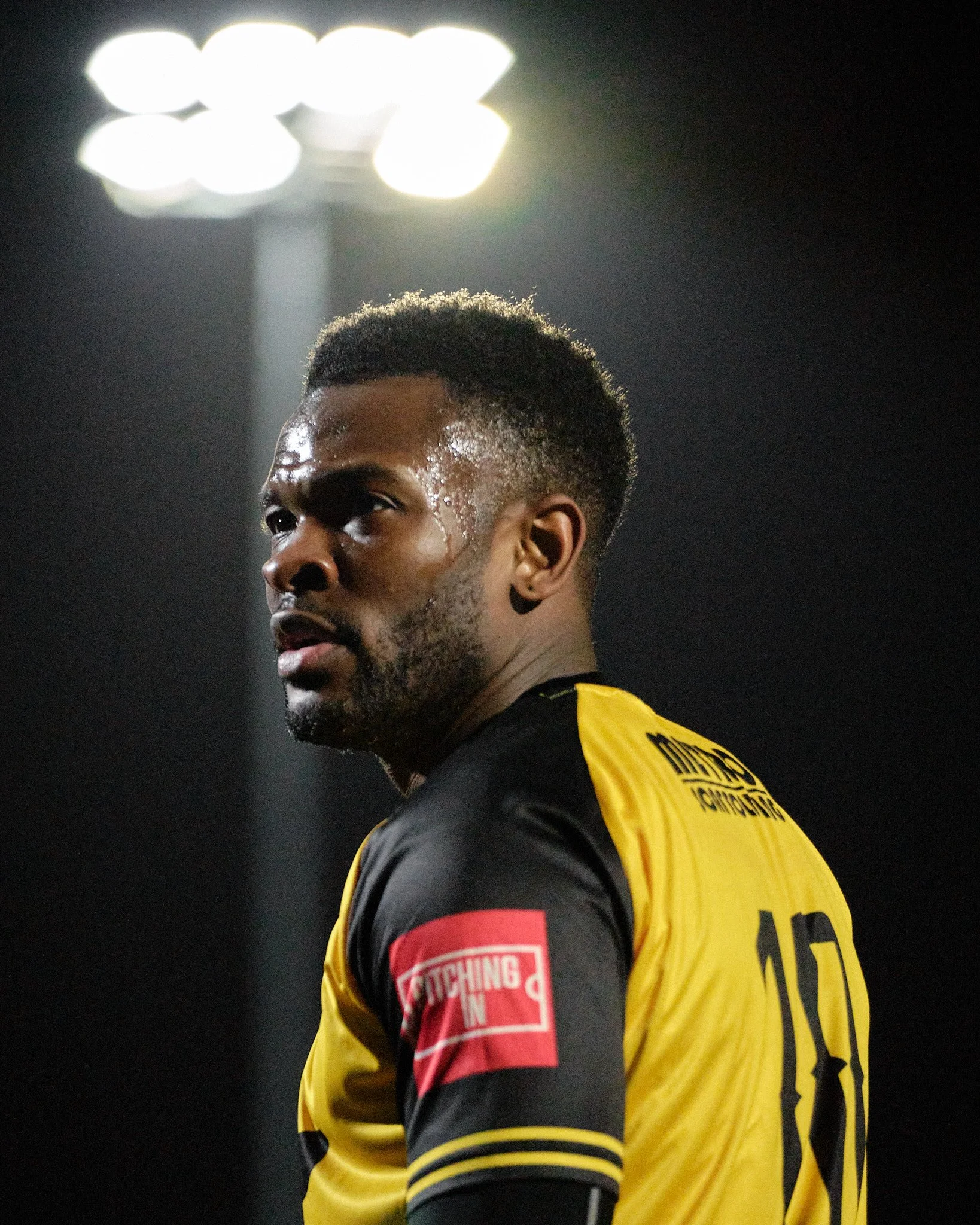 Anthony Cook plays for Cray Wanderers at Bromley FC under the floodlights.