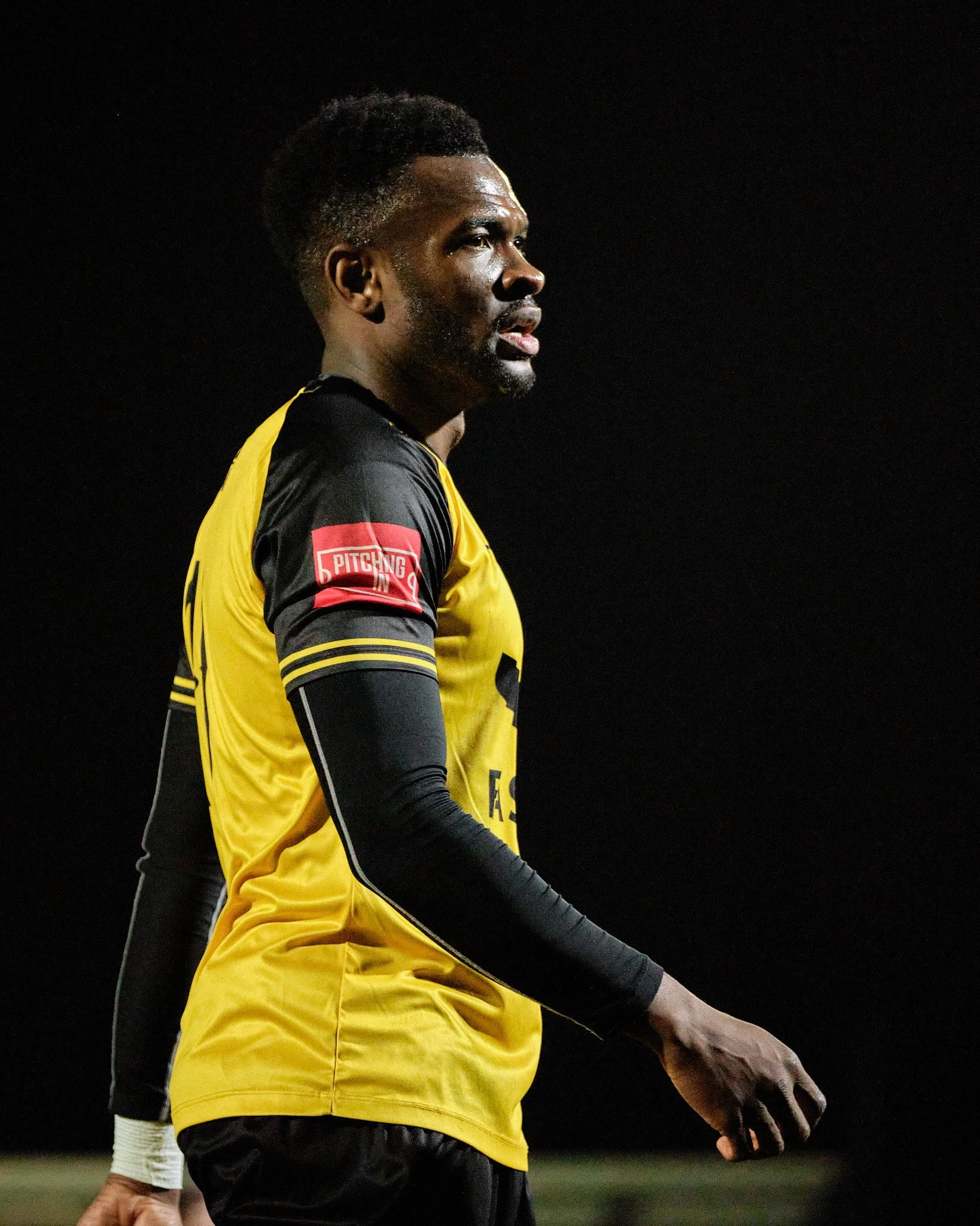 Anthony Cook plays for Cray Wanderers at Bromley FC under the floodlights.