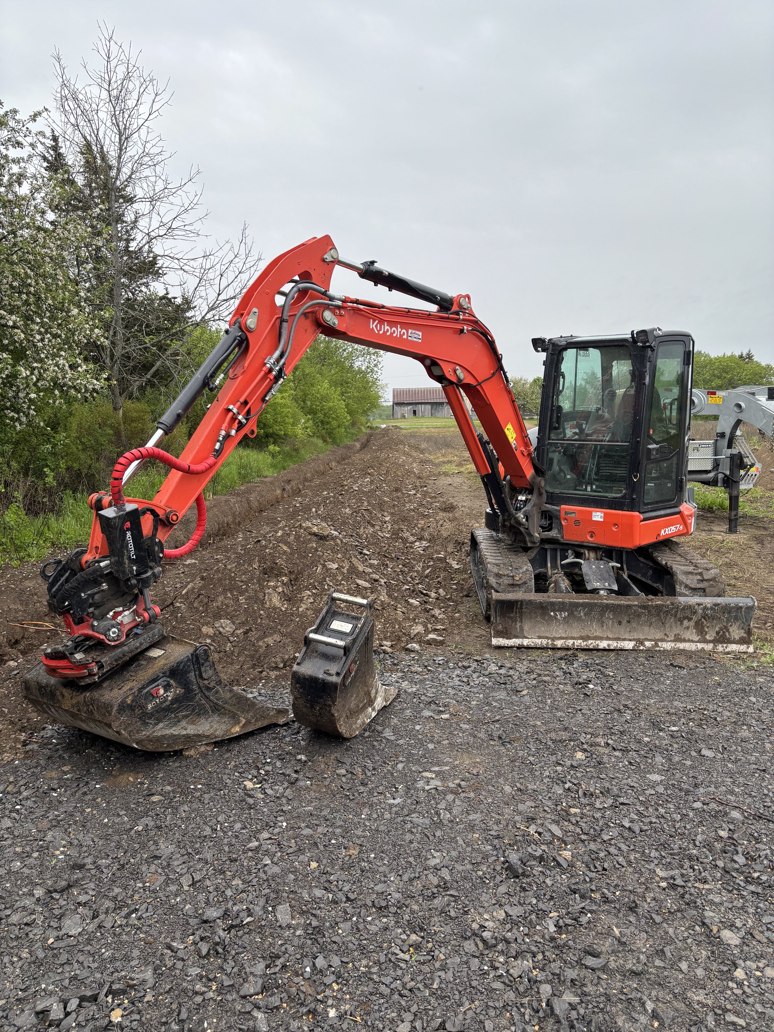700' of Electrical trench through a rocky farm field.  With our Rototilt trenching bucket there is no job too big!