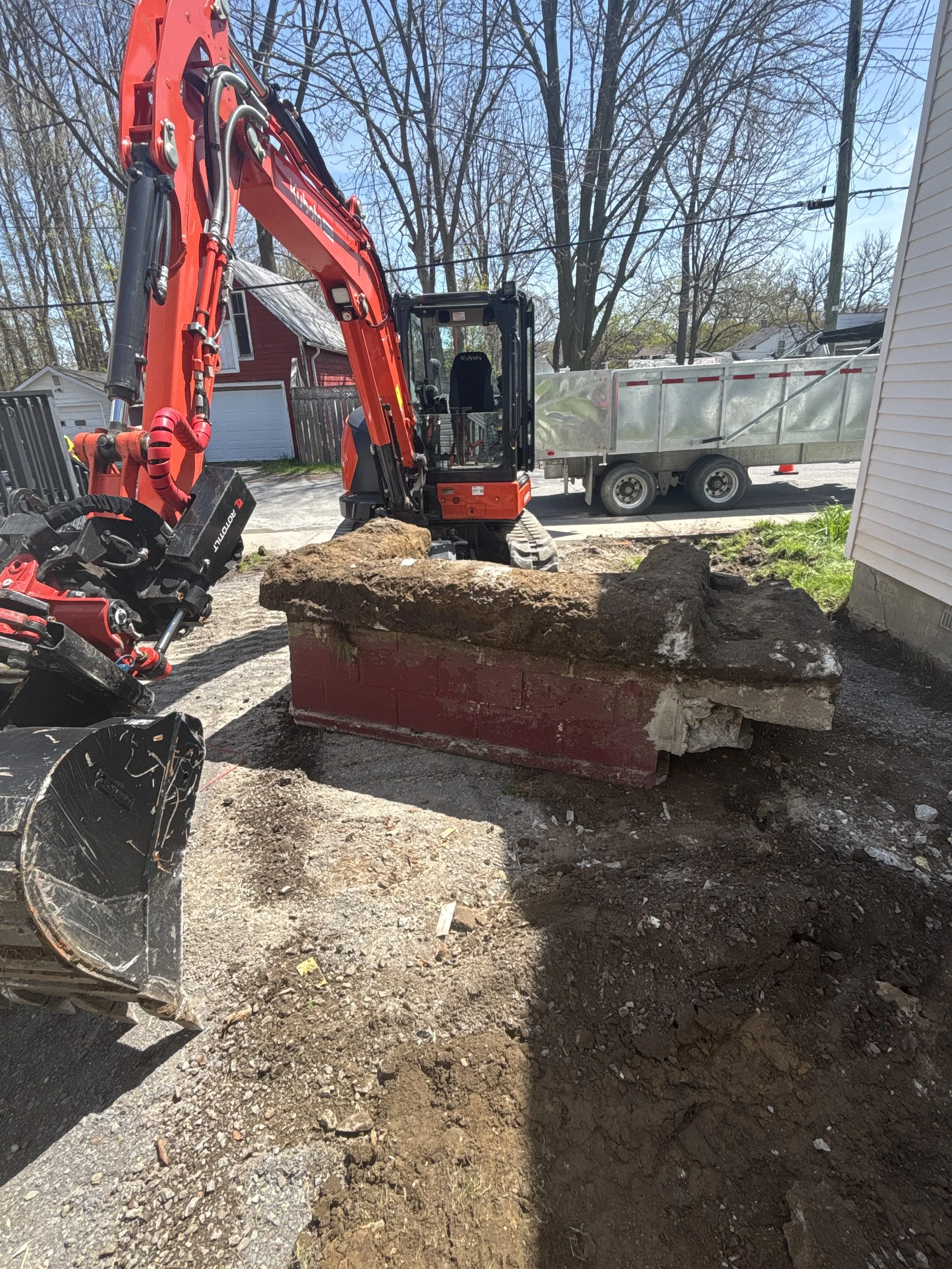 The right equipment makes unexpected site conditions easy!  Concrete removal against a stone foundation is always tricky, but with the right knowledge and tools it can be done right, and done efficiently.  