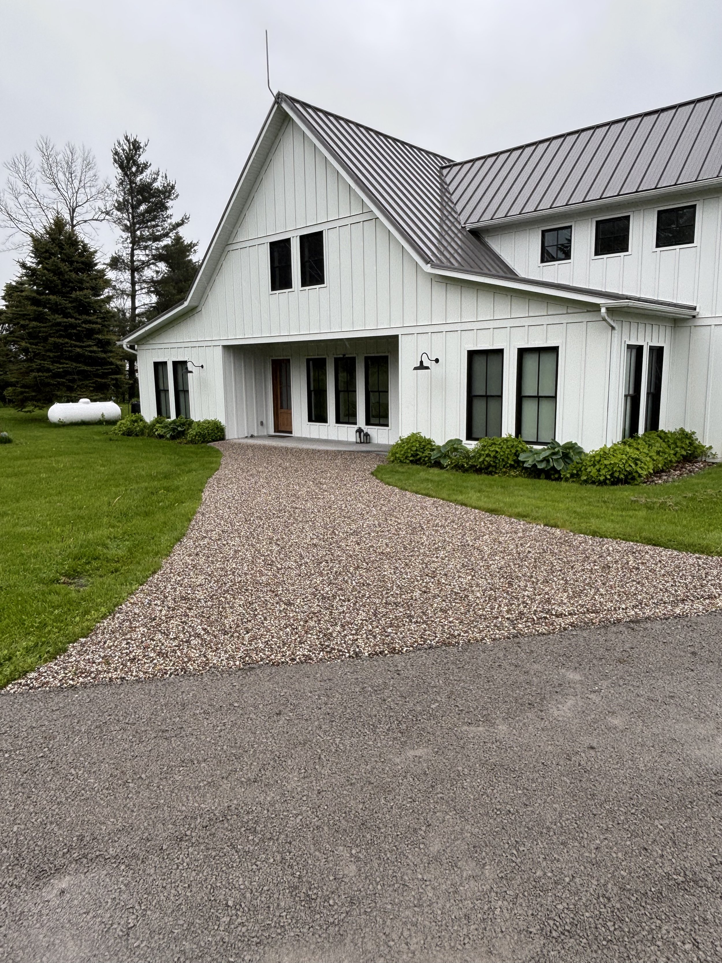 A beautiful premium pea stone walkway installed as part of our gravel driveway resurfacing project in Waupoos