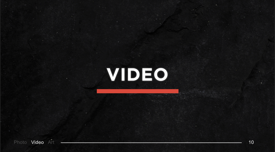 Dark textured screen displaying a menu with the word 'VIDEO' highlighted in the center, and options for Photo, Video, and Art at the bottom left.