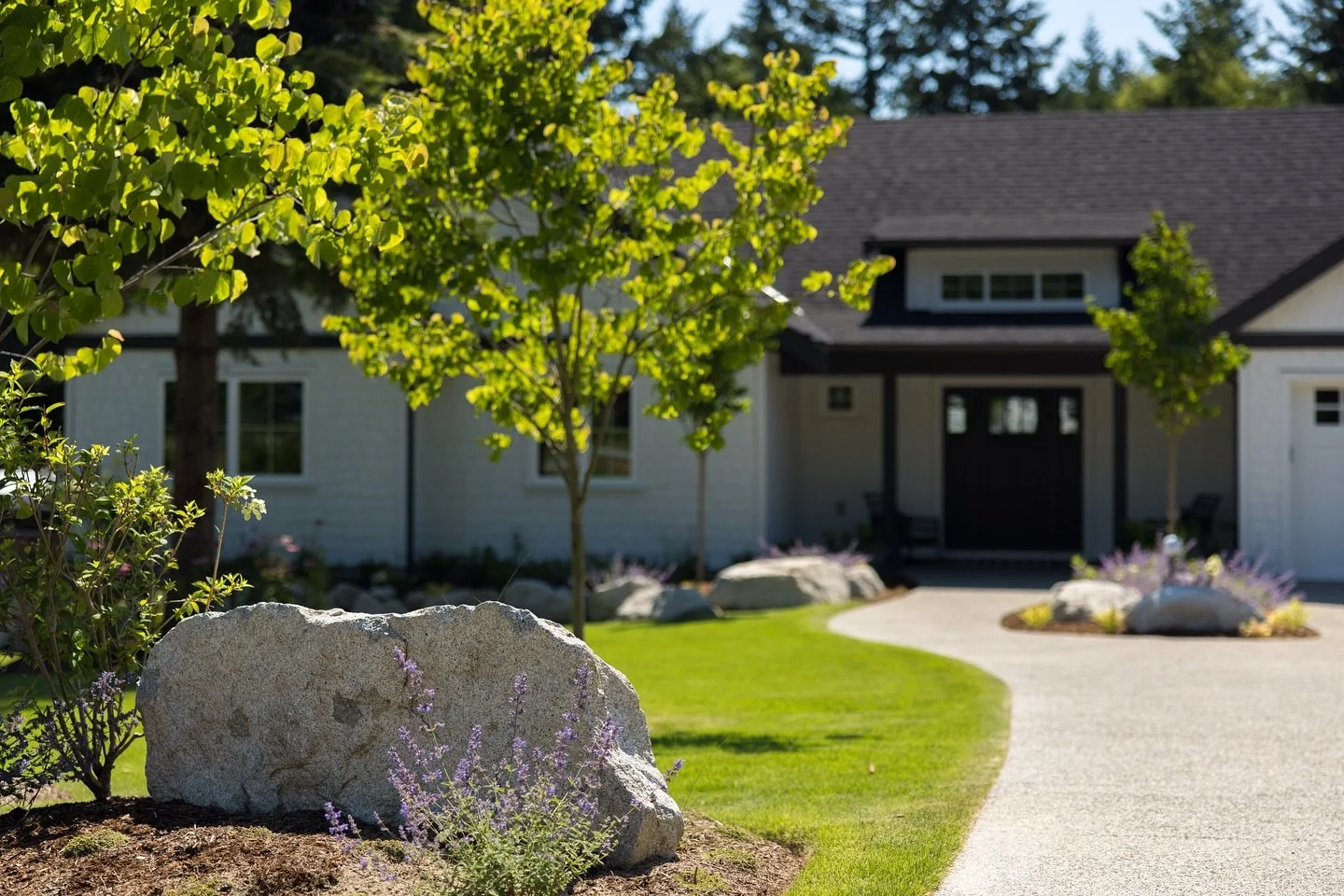 Talk about curb appeal! 😍 We love the clean lines and vibrant contrast in this finished front yard project. The lush green lawn and the pop of color from the new tree plantings create a welcoming and stunning entrance. Ready to elevate your home&rsq