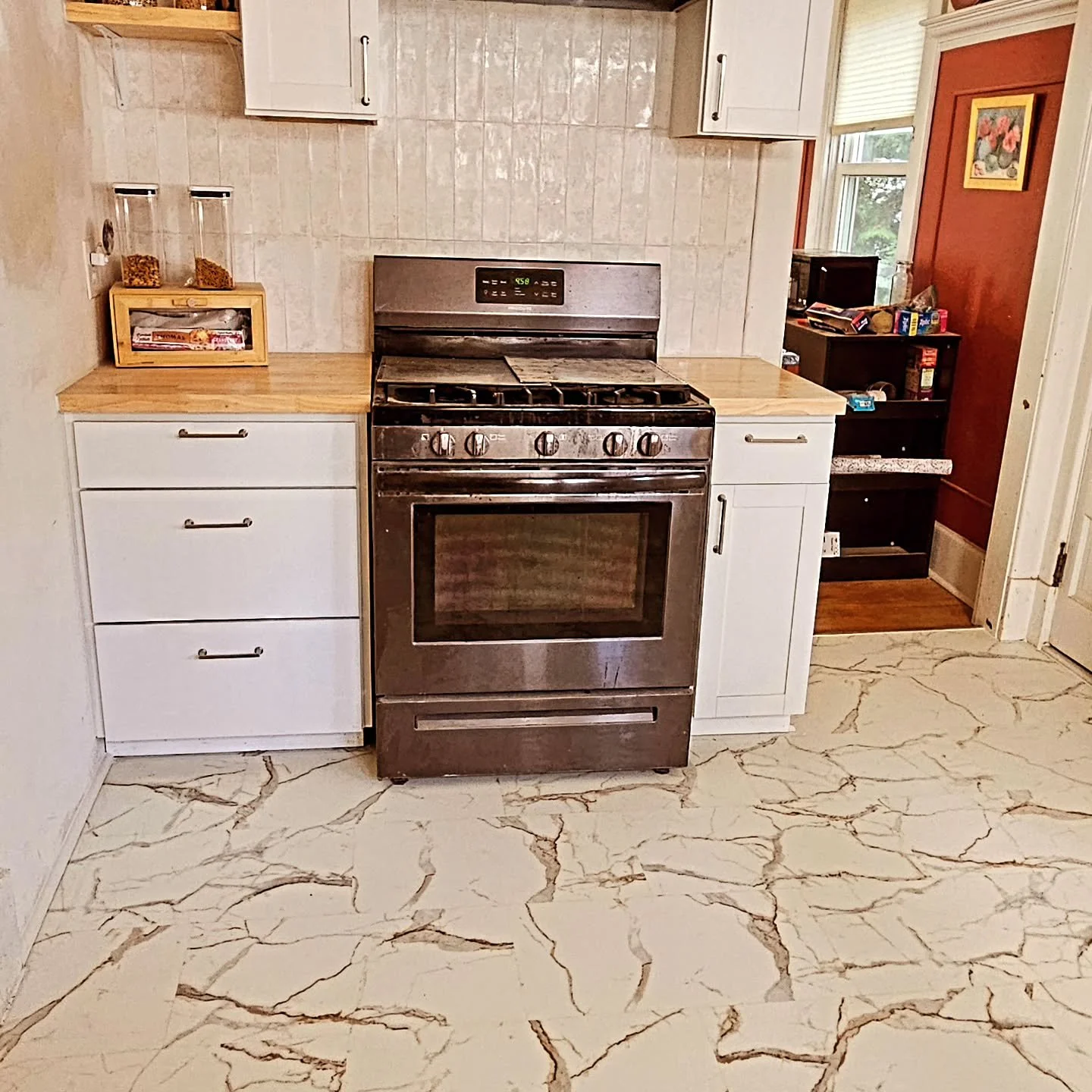 This kitchen didn&rsquo;t just get an upgrade &mdash; it got a whole new identity. Old cabinets and flooring out, new cabinetry, tile-look vinyl floors, fresh backsplash, and warm butcher block countertops in. Same layout, completely different vibe. 