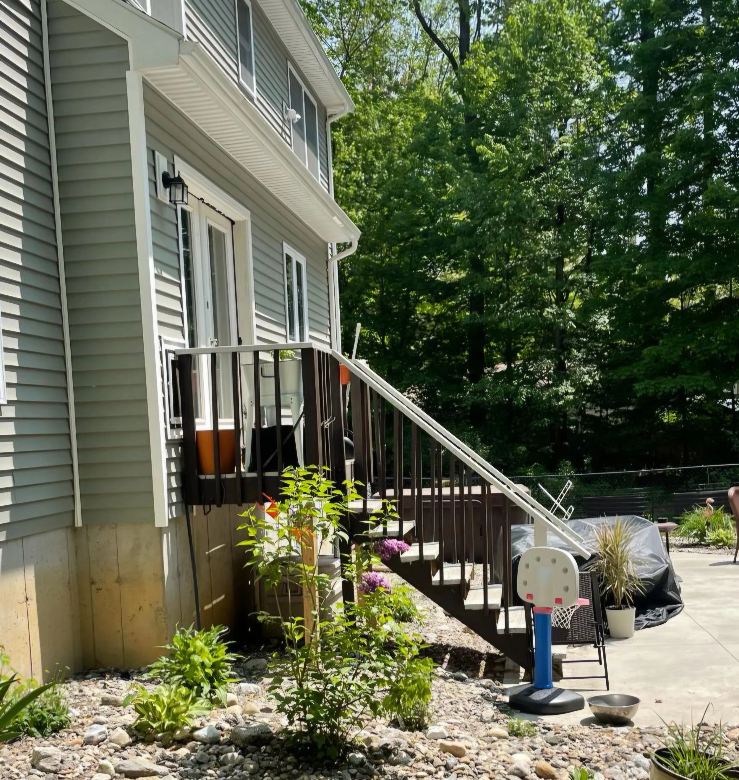 Before photo of the original outdoor deck stairs before demolition and rebuild. Regional Remodeling transformed this exterior entry with a brand-new Trex deck, updated stairs, railings, and a fresh, modern design built from scratch. 
Serving Schenect