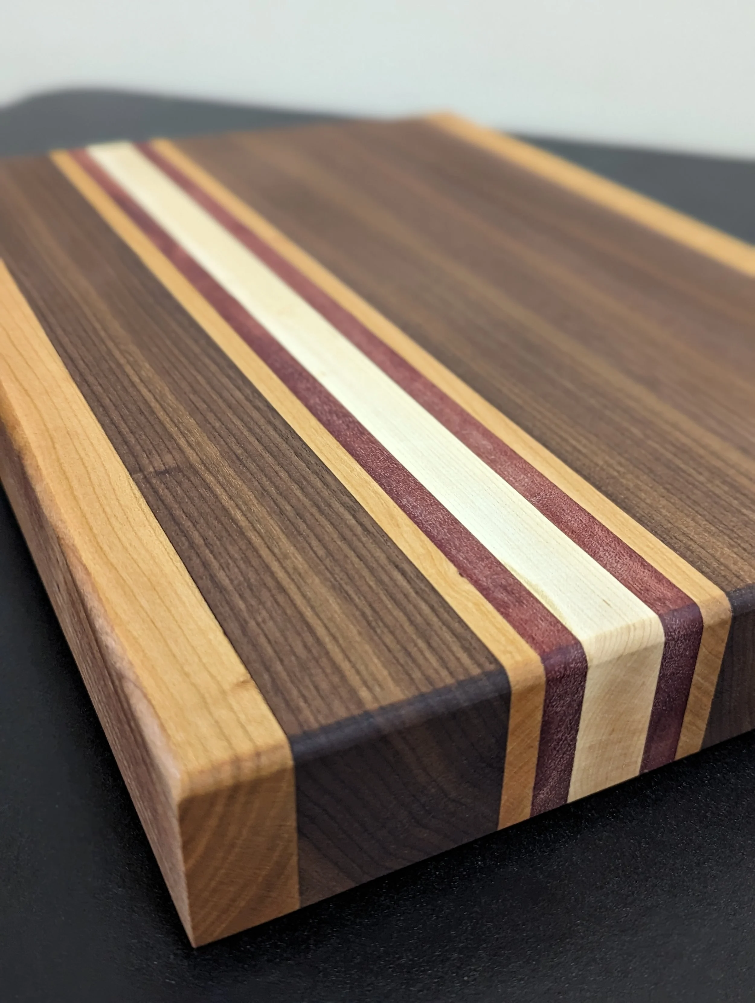 Butcher Block Cutting Board
-Solid Cherry, Walnut, Maple and a Hint of Purple Heart 
-Food Safe Finish