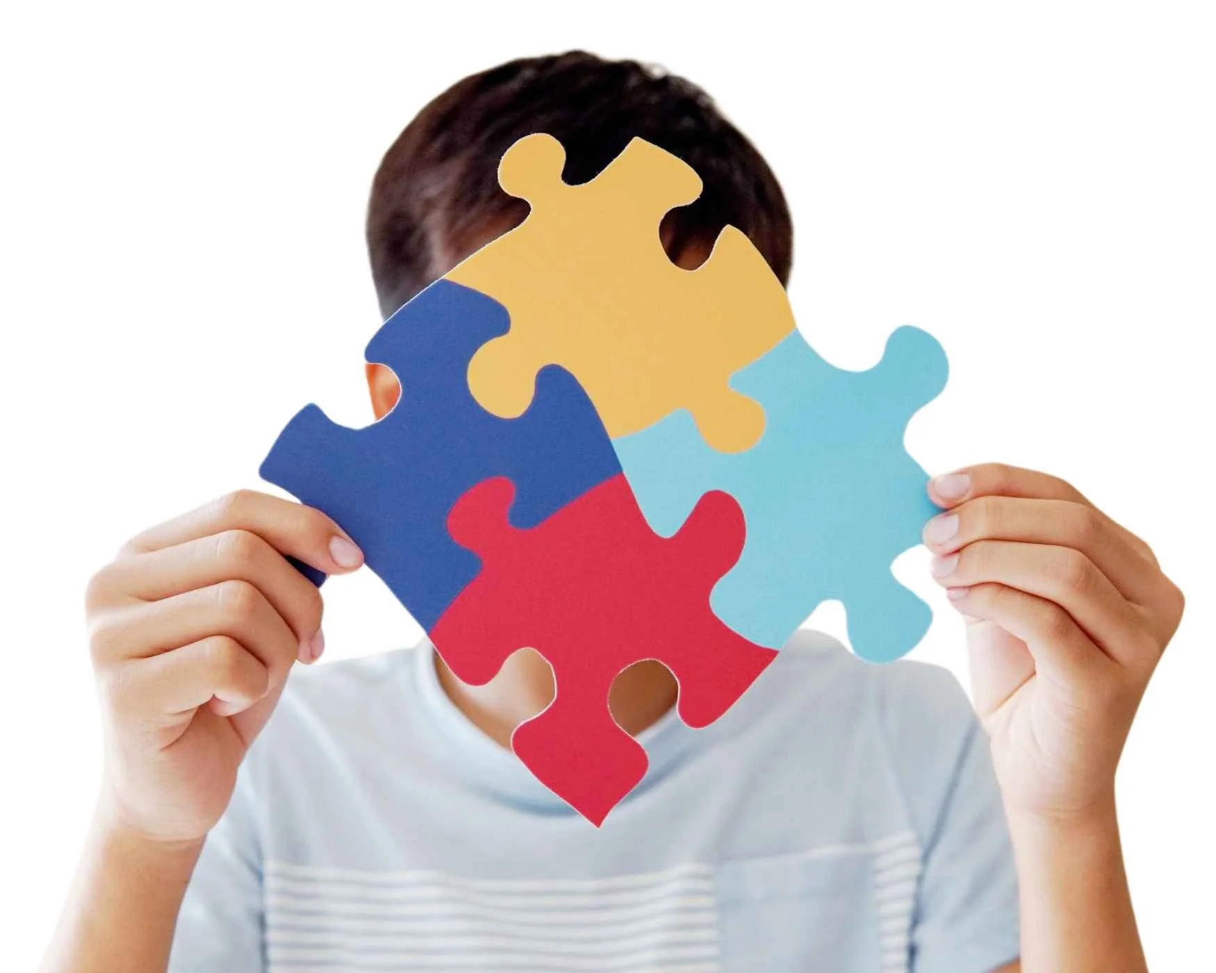 A person holding four large, colorful puzzle pieces together.
