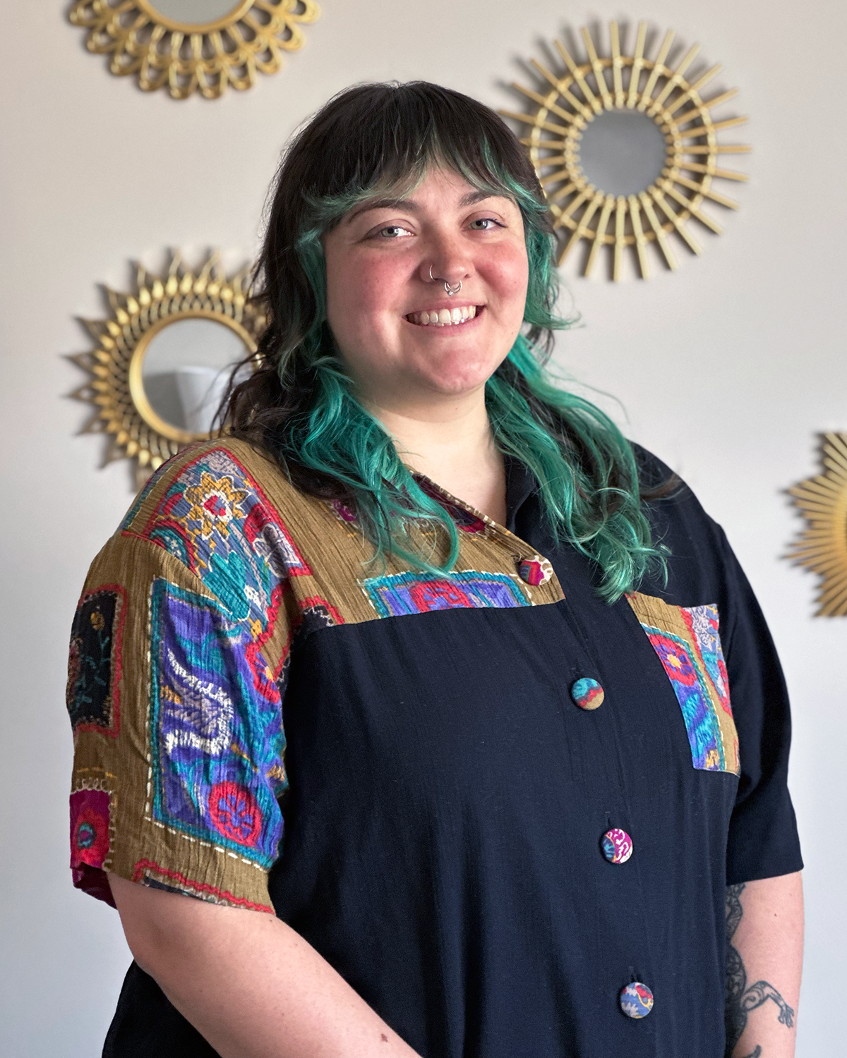 Kate Eckstine sits in a chair in an Evolve Wellness therapy room.