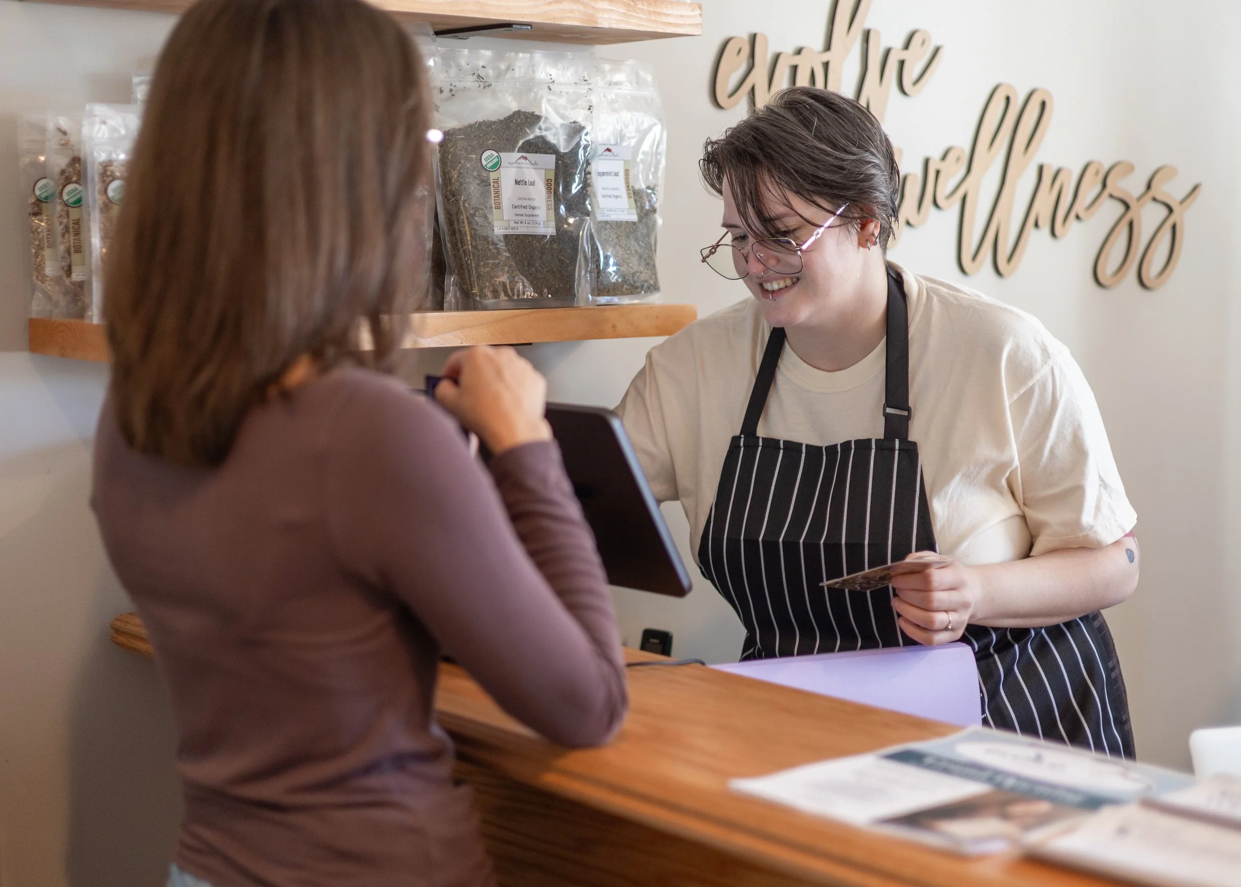 Rebekah rings out a customer behind the Herbal Bar.