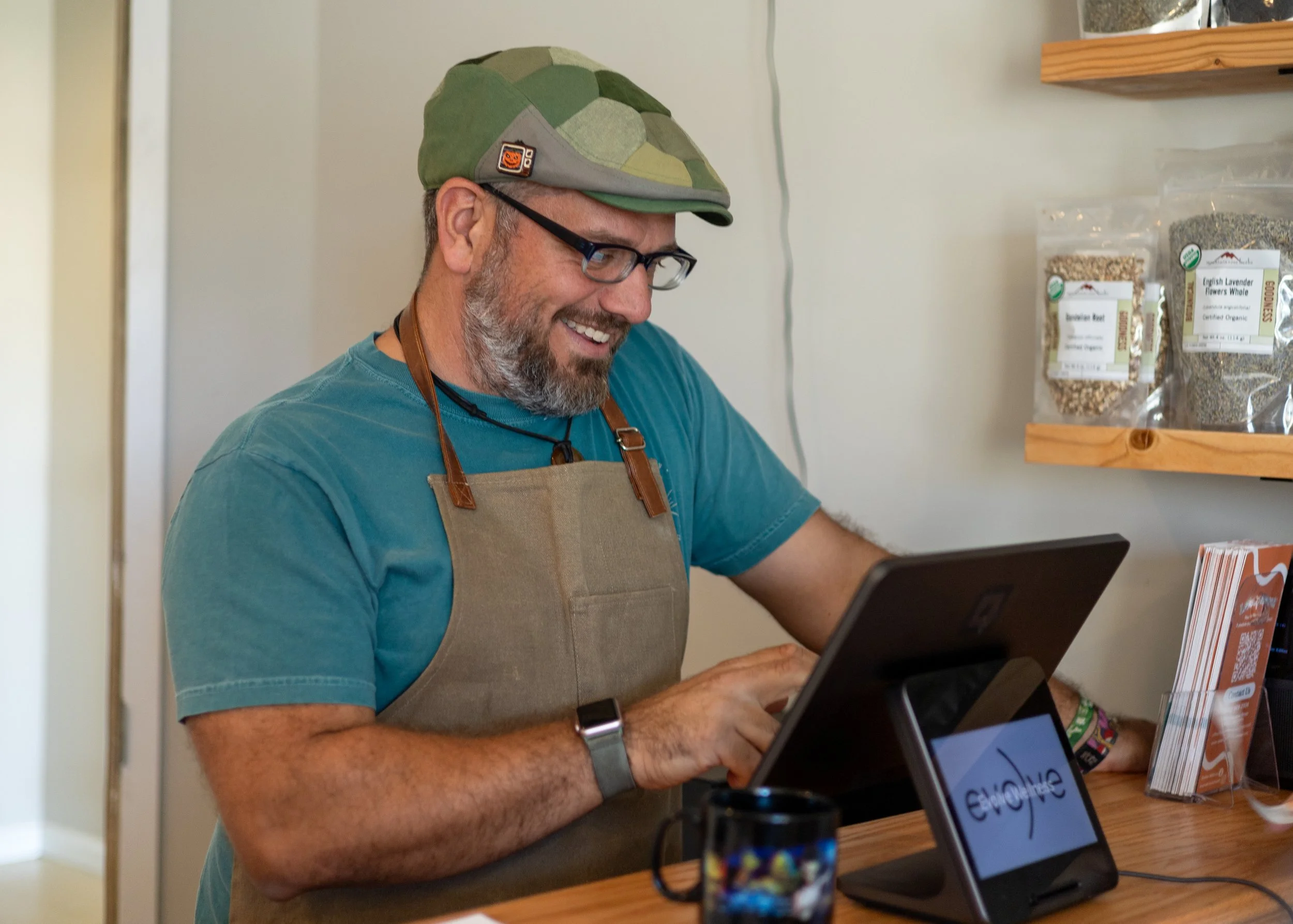 Charles rings up a purchase at the Herbal Bar.