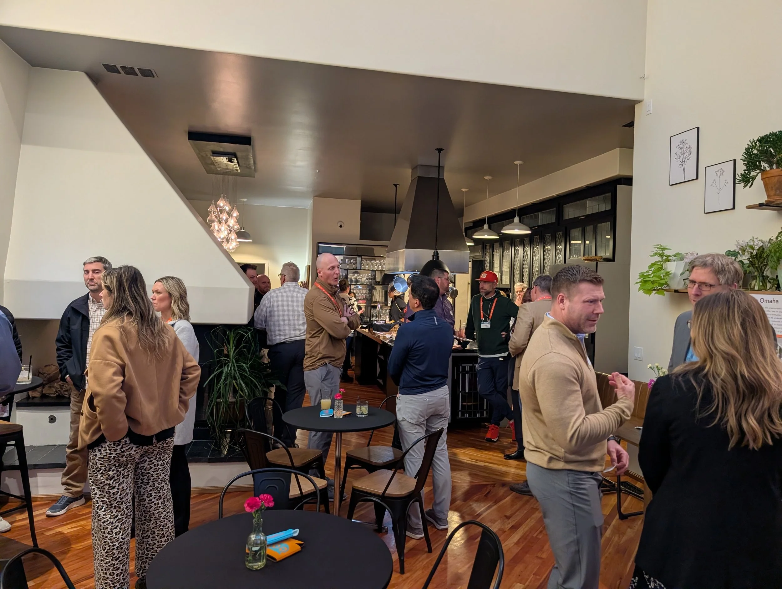 People socializing at a restaurant or cafe with a bar and warm lighting.