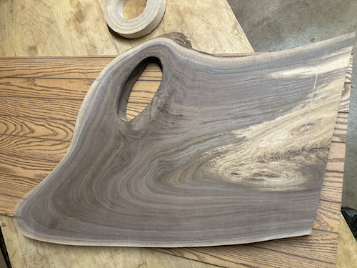 Board after cleaning up the back, cutting off the excess bark on top, and before cutting a straight edge on the bottom near the white wood.