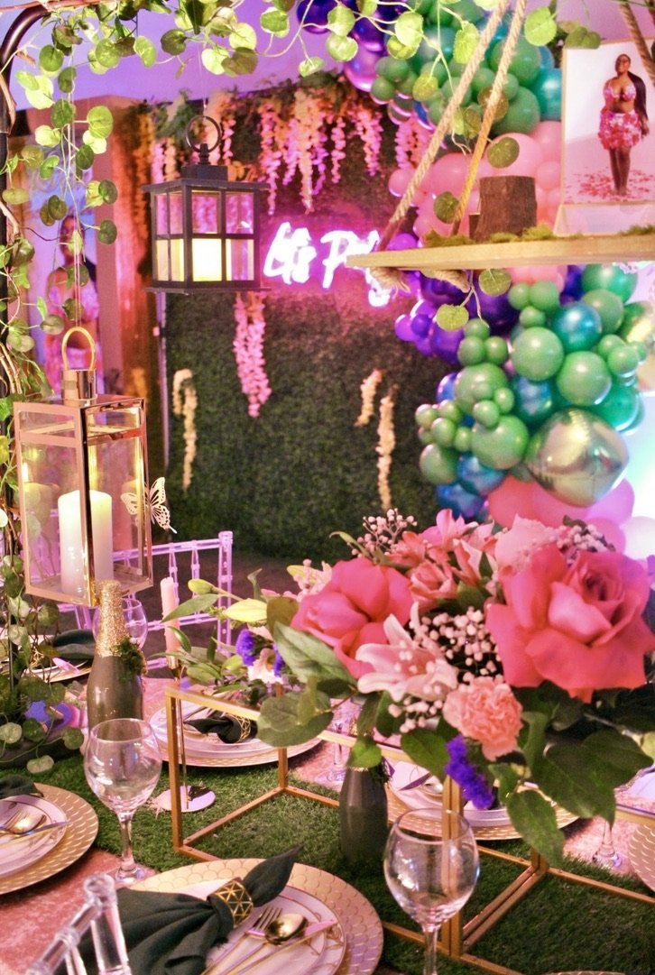 Laurie’s customers, Mariana and Carmen holding hands on a green lawn on their wedding day.