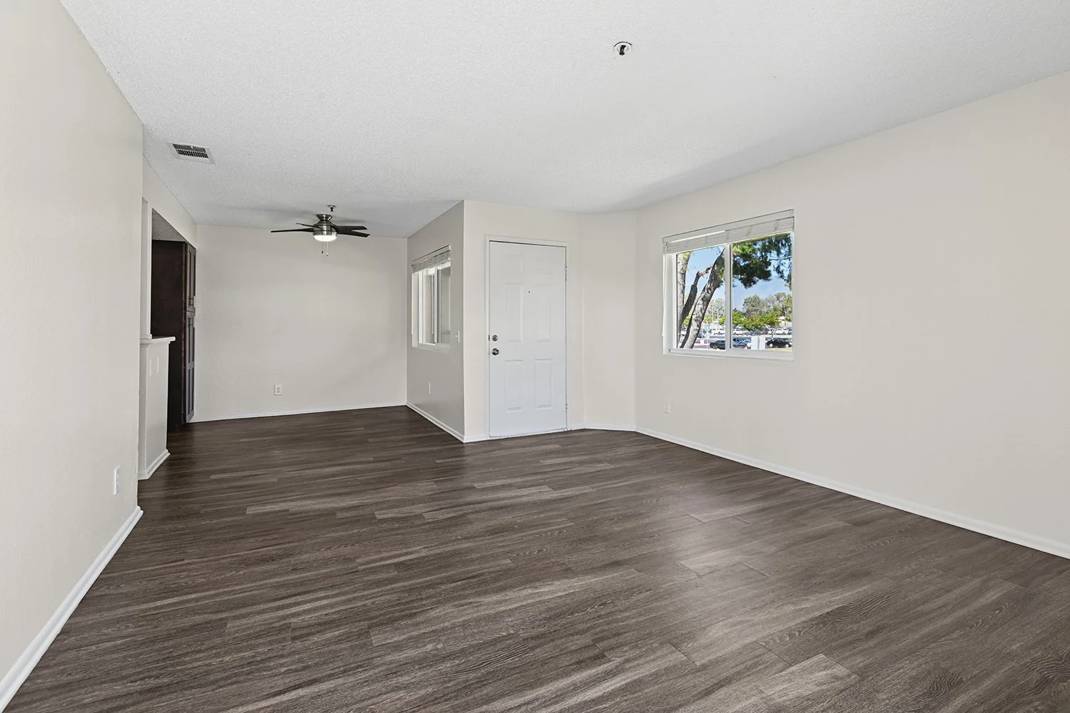 Spacious living area in Citrus Heights 3 Bedroom apartment home with view onto private patio, and open concept leading to dining nook. Plenty of windows allow for gorgeous natural lighting. 