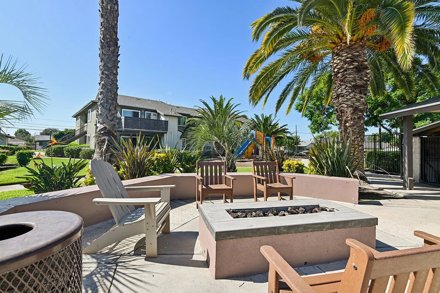 Fire pit at Citrus Heights Apartment homes surrounded by lounge seating for resident relaxation and enjoyment. 