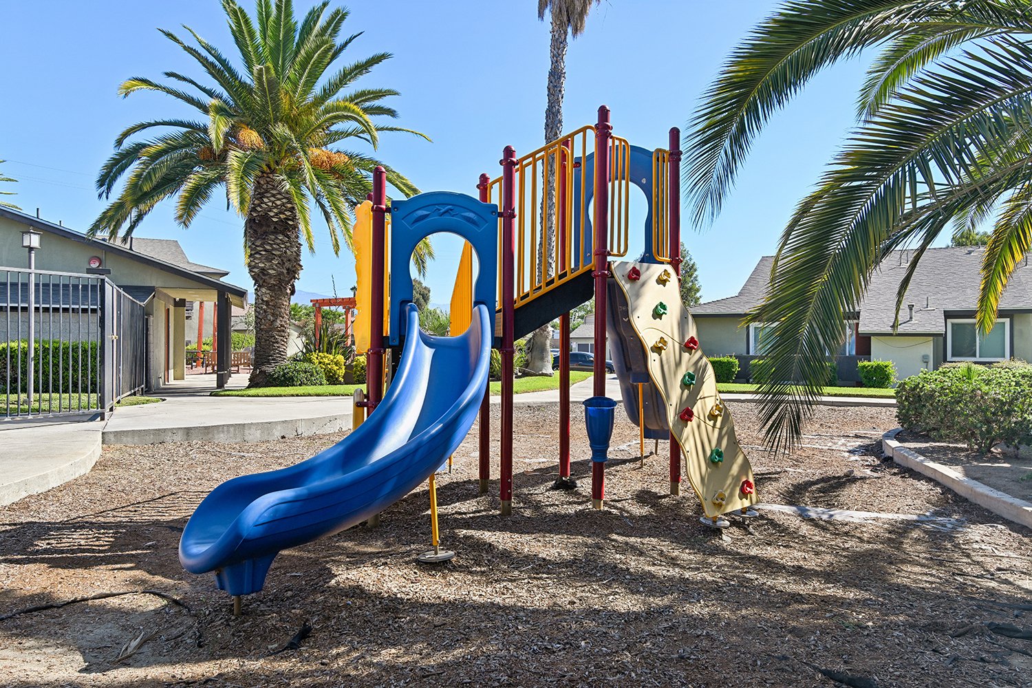 Play Park at Citrus Heights with slide and fun play structure surrounded by trees and park-like landscaping.