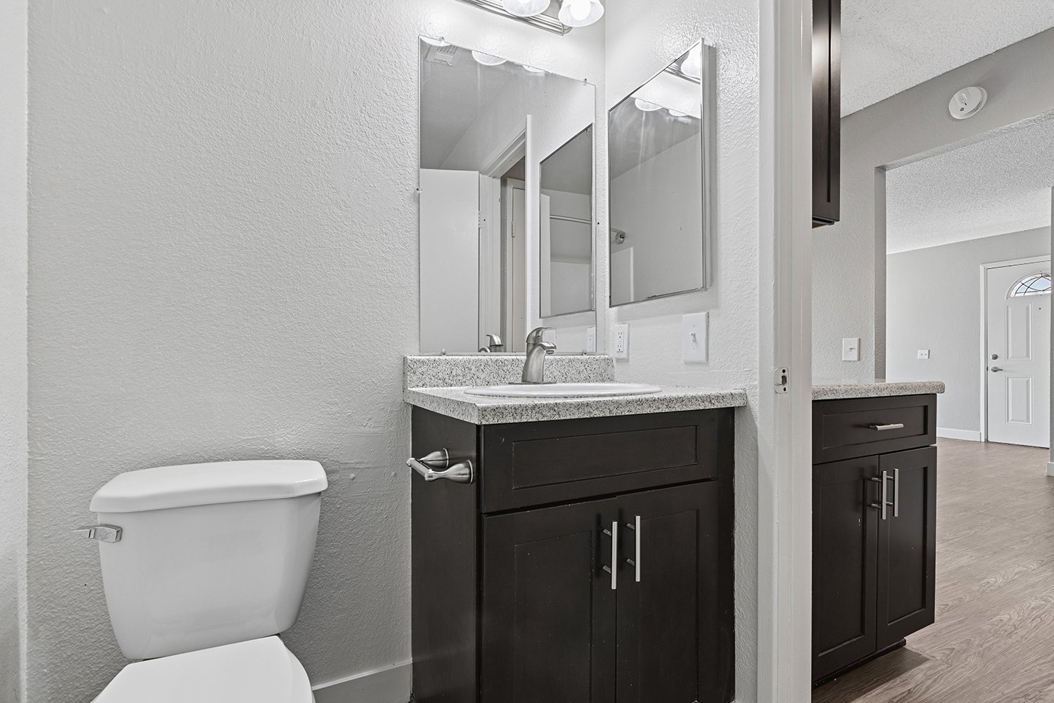 Bathroom in Citrus Heights 1 Bedroom Apartment home with dark cabinetry and plank flooring. 