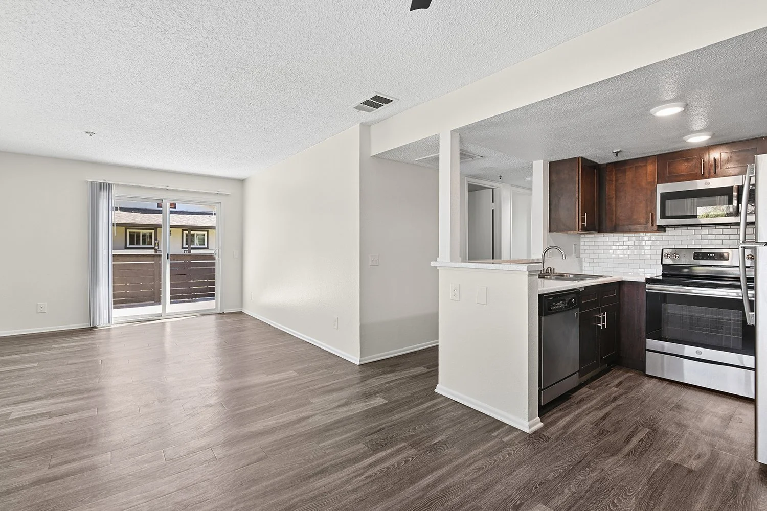 Spacious living area in Citrus Heights 3 Bedroom apartment home with view onto private patio, and open concept leading to dining nook. Plenty of windows allow for gorgeous natural lighting. 