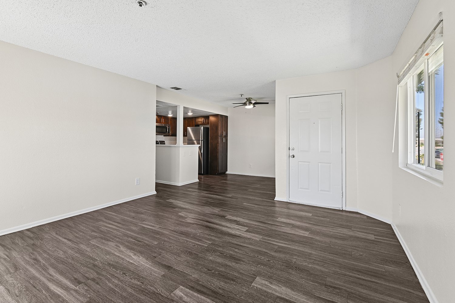 Spacious living area in Citrus Heights 3 Bedroom apartment home with view onto private patio, and open concept leading to dining nook. Plenty of windows allow for gorgeous natural lighting. 