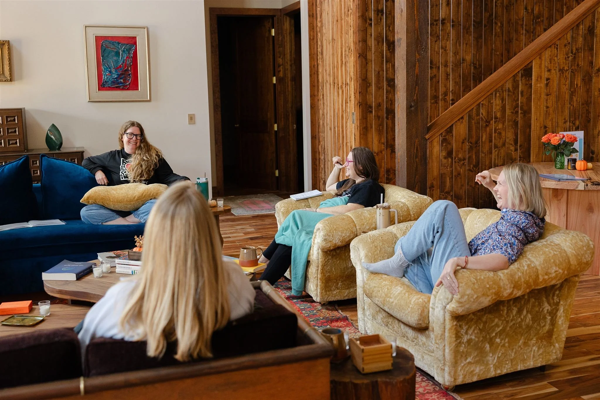 Four laughing around fireplace.jpg