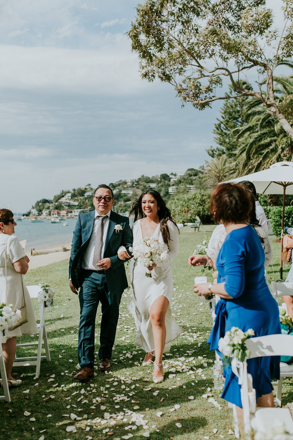 Laurie’s customers, Fernando and Kate embracing by the lake on their wedding day.